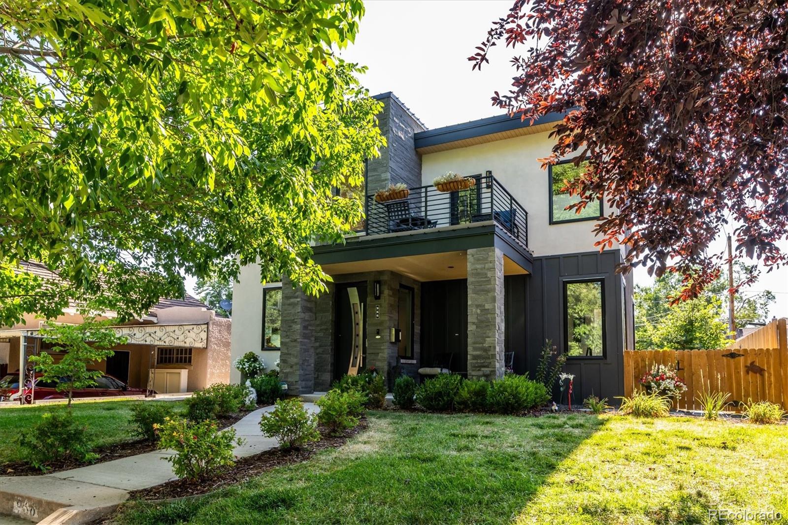 Built in 2020 and perfectly situated in the heart of Congress Park, this exceptional residence offers 4 bedrooms, 4 bathrooms, and more than 3,300 square feet of thoughtfully designed living space. Contemporary style, the home features quality craftsmanship, refined finishes, and a floor plan designed for both comfortable everyday living and effortless entertaining. Its striking curb appeal creates a stunning first impression. The main level centers around a chef-inspired kitchen featuring a large waterfall quartz island, designer tile backsplash, shaker cabinetry, upgraded stainless steel appliances, a professional-style range with hood, modern lighting, and an expansive walk-in pantry. The kitchen flows seamlessly into the dining area and spacious family room, creating an inviting space for gathering w/family and friends. Upstairs, the private primary retreat includes a spa-inspired bath with dual shower heads, a custom walk-in closet with built-in organizers, and a balcony that provides the perfect place to enjoy a morning coffee or unwind in the evening. The upper level also includes a secondary bedroom, a full bathroom, and a conveniently located laundry room. The newly finished basement extends the home’s versatility with a generous recreation room, two additional bedrooms (1 non-conforming), a full bathroom, offering endless possibilities for guests, a home office, fitness space, or media room. Outside, enjoy a covered patio overlooking a private backyard with garden space, providing an ideal setting for outdoor dining or relaxing. The attached two-car garage opens into a thoughtfully designed mudroom complete with custom built-ins and a dedicated pet station. Ideally located within walking distance of Congress Park, the popular shops and restaurants along 12th Avenue, and Cherry Creek. Close to City Park, downtown Denver, and major highways. Rare opportunity to own a newer home that blends seamlessly into the charm and character of the neighborhood