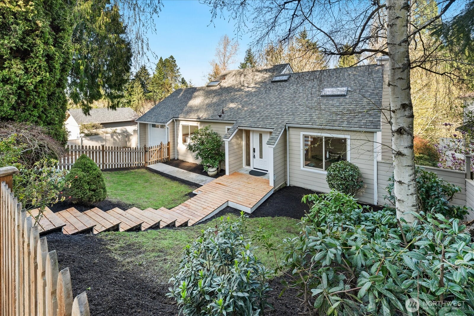 Welcome to Lake Forest Park. This sun-filled, fully updated four-story home offers an exceptional blend of light, space, and versatility.  South-facing decks and a stunning upper-level sunroom invite natural light to pour into the home, while soaring ceilings, skylights, and expansive living areas create a bright, open, and inviting atmosphere throughout.  A thoughtful reimagining of a classic design, the home offers a flexible layout with excellent potential for multigenerational living, guest accommodations, hobbies, or lower-level income opportunities. The upper-level sunroom provides a peaceful space to relax, while the distinctive primary suite, vaulted ceilings on the main level, and generous room sizes set this home apart.  A dedicated workshop or craft room with its own bath adds even more functionality. Each level opens to a spacious deck, creating a seamless connection to the outdoors.  Recent updates include oak hardwood floors and over $450,000 in improvements, A New roof, interior and exterior paint, siding and a concrete driveway.  Do not let the modest street presence mislead you. This home lives much larger than it appears and is best experienced in person.  Ideally located near neighborhood favorites, schools, and daily amenities, Bike the Burke-Gilman Trail with easy access to Redmond and Seattle. Lake Washington, parks, and local gathering spots are all nearby.  A remarkable transformation of a classic home, this residence truly feels better than new.
