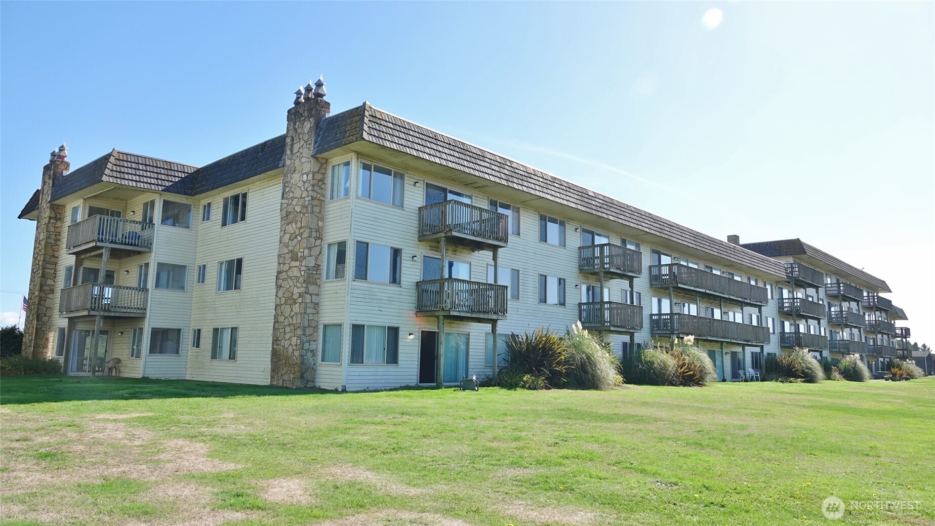 OCEAN/DUNES FRONT HOTEL CONDO! 2 BD, 1.5 BA CORNER Condo available on the 1st floor (#124) in the Polynesian Hotel in downtown Ocean Shores. FULLY-FURNISHED with 965 sq.ft. ~ CORNER unit with lots of windows for natural light with WESTERN, Eastern, Northern and Southern views. Comfortable Living Room with a hide-a-bed couch, presto-log fireplace, and a slider door to the East-side Patio. Dining Area with a slider to the West-side Patio, which leads out to the Hotel's backyard and then into the Dunes Area. Fully-equipped Kitchen with all appliances and dishes, and a large Desk. Large Master Bedroom with (2) Queen-sized beds, a slider to the East-side Patio, and an attached 1/2-Bath. Another Full Bath, and a Bedroom with (1) Queen/Full Bed. Ran as a HOTEL ~ OWNER CAN STAY UP TO 30 DAYS/YEAR at (currently) $75 per stay for the Cleaning Fee (per stay, NOT per night). Rental Income is divided as follows: 22% of the unit's revenue goes to the management co.; (currently) $1,218.14/mo to the HOA; any remaining revenue goes to the Owner. Owner is responsible for all of the items within their unit. HOA pays for all other expenses, ie utilities, building maintenance and insurance, etc. This unit is currently a pet (dog) unit, which adds to the unit's revenue ($69/stay). On-site heated indoor pool & hot tub, social room, game room, lobby, elevator, a backyard lawn area, and a park. Property backs the Dunes Area (the Ocean/Beach lies beyond the Dunes).