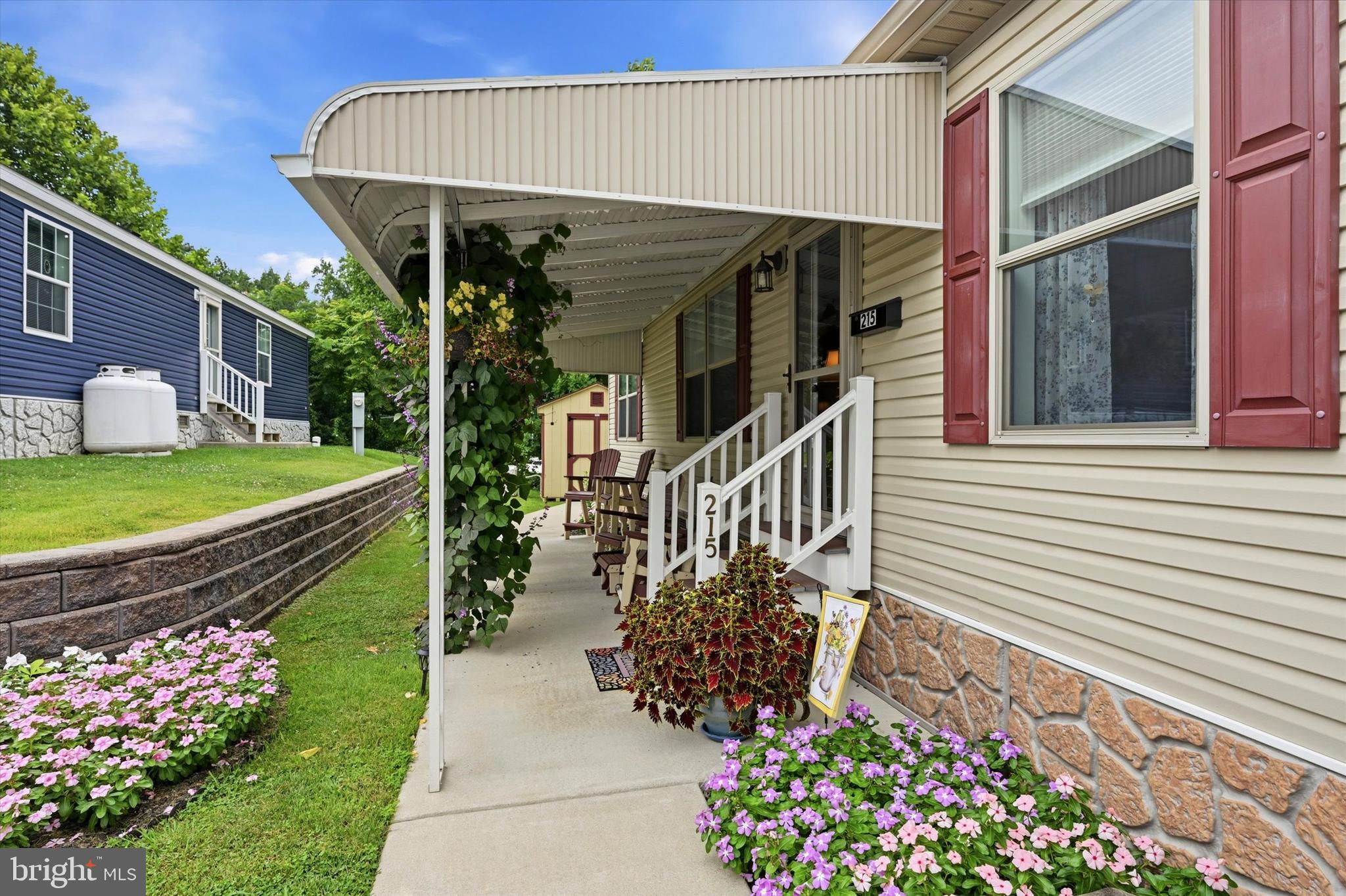Welcome to easy, elegant one-floor living in this beautifully custom-designed 2020 double-wide manufactured home, located in a desirable 55+ community. Perfect for those looking to downsize without compromising on space, style, or comfort, this rare three-bedroom, two-bath home offers modern convenience in a thoughtfully designed layout.The heart of the home is the stunning culinary kitchen, featuring a large center island, stainless steel appliances, a farmhouse sink, abundant cabinetry, and an open design that flows seamlessly into the designated dining area and spacious, light-filled living room—ideal for entertaining or simply relaxing at home.The private primary suite is a peaceful retreat, complete with a generously sized bedroom, a luxurious en-suite bath, and a large walk-in ceramic tile shower. Two additional bedrooms and a full hall bath provide comfortable accommodations for guests, hobbies, or a home office.A convenient laundry room with direct access to the rear entrance adds everyday functionality. Outside, you’ll enjoy a welcoming covered patio surrounded by attractive landscaping—perfect for morning coffee or evening gatherings. An additional storage shed and two-car parking complete the package.Additional Special Features include: recessed lighting, ceiling fans, many Large walk-in closets, Generac generator, Gutter Guards w/transferable warranty, HVAC serviced annually, New Bosch DW, neutral tones t/o, and many more beautiful features you will absolutely fall for.Offering low-maintenance living with exceptional custom features, this move-in-ready home is an outstanding opportunity to enjoy comfort, convenience, and an active 55+ lifestyle. Village Green requires community approval for all new residents. Seller moving out October 15th. Settlement to be 10/15 or soon after. The seller requires the buyer to complete this process prior to submitting an AOS. *The usual turn around is about 72 hours.