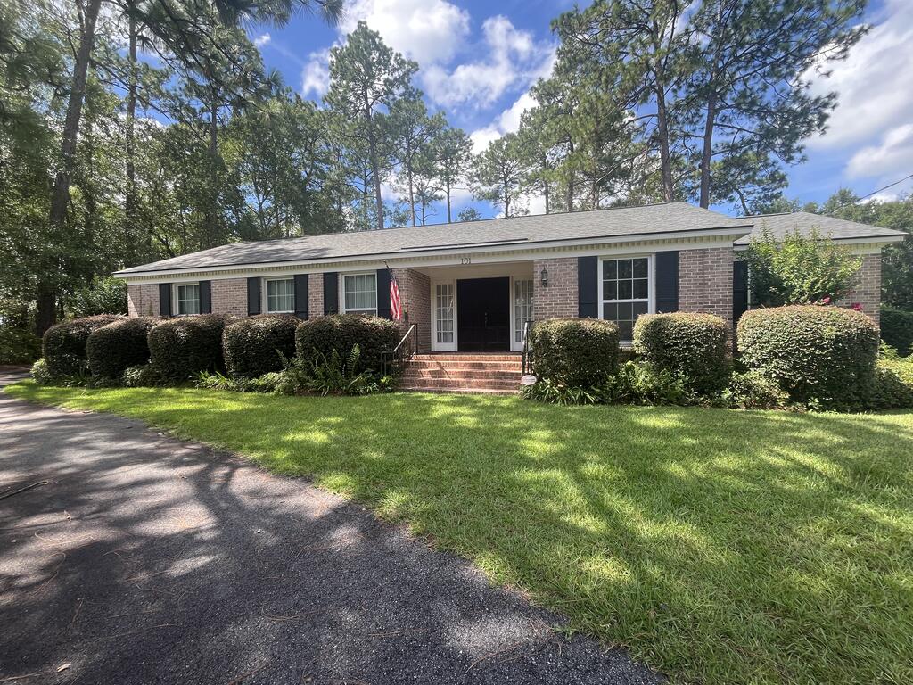 Open the door to charm and character. This four bedroom, two and a half bath is everything you have been looking for. The large foyer has beautiful hardwood flooring ,tons of natural light and two sets of double doors.  Located off of the foyer is a formal sitting area that could be used to entertain guests. This home has a formal dining room plus an eat in kitchen. The open kitchen looks into the family room that has exposed beams and a wood burning fireplace.  There is a  flex room located off of the kitchen that could be an office space, or craft area. Outside you will find a storage building to house all of the tools and play equipement. The two car carport is located on the back of the house and offers a storage room.  All of this within close distance to Brookwood school, restaurants and shopping. This home will not last long. Schedule a showing today.