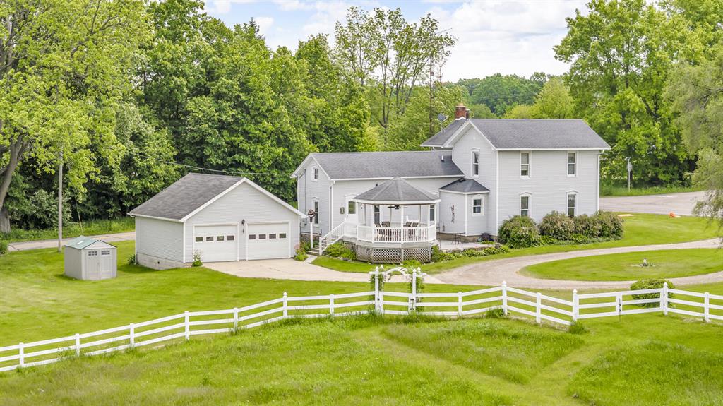 TURN OF THE CENTURY HOBBY FARM NW JACKSON COUNTY only 1.5 miles to I-94, Exit #133 - great for commuters. Peaceful setting surrounds this beautiful 4.5 acre farm (additional acreage may be available) - perfect for horses, hobby farming, homesteading or simply enjoying wide-open spaces. Well maintained vinyl sided 1,900 sq. ft. home features 3 BR \ 2 BA, w/1 BR & bath on the main flr. Gorgeous custom BR furniture upstairs stays. Large nicely updated eat-in kitchen w/granite countertops. Formal dining rm, charming living rm w/wood burner, wood storage closet AND a parlor/library w/blt-in bookcases. 1st Flr laundry/mud rm (hidden door to basement). Relax in the vinyl/composite gazebo & enjoy views fields. 30x60 pole barn, ''run in'' barn, storage shed & 24x24 garage.  Enjoy the best of rural living without sacrificing comfort. FHA/VA/RD terms avail