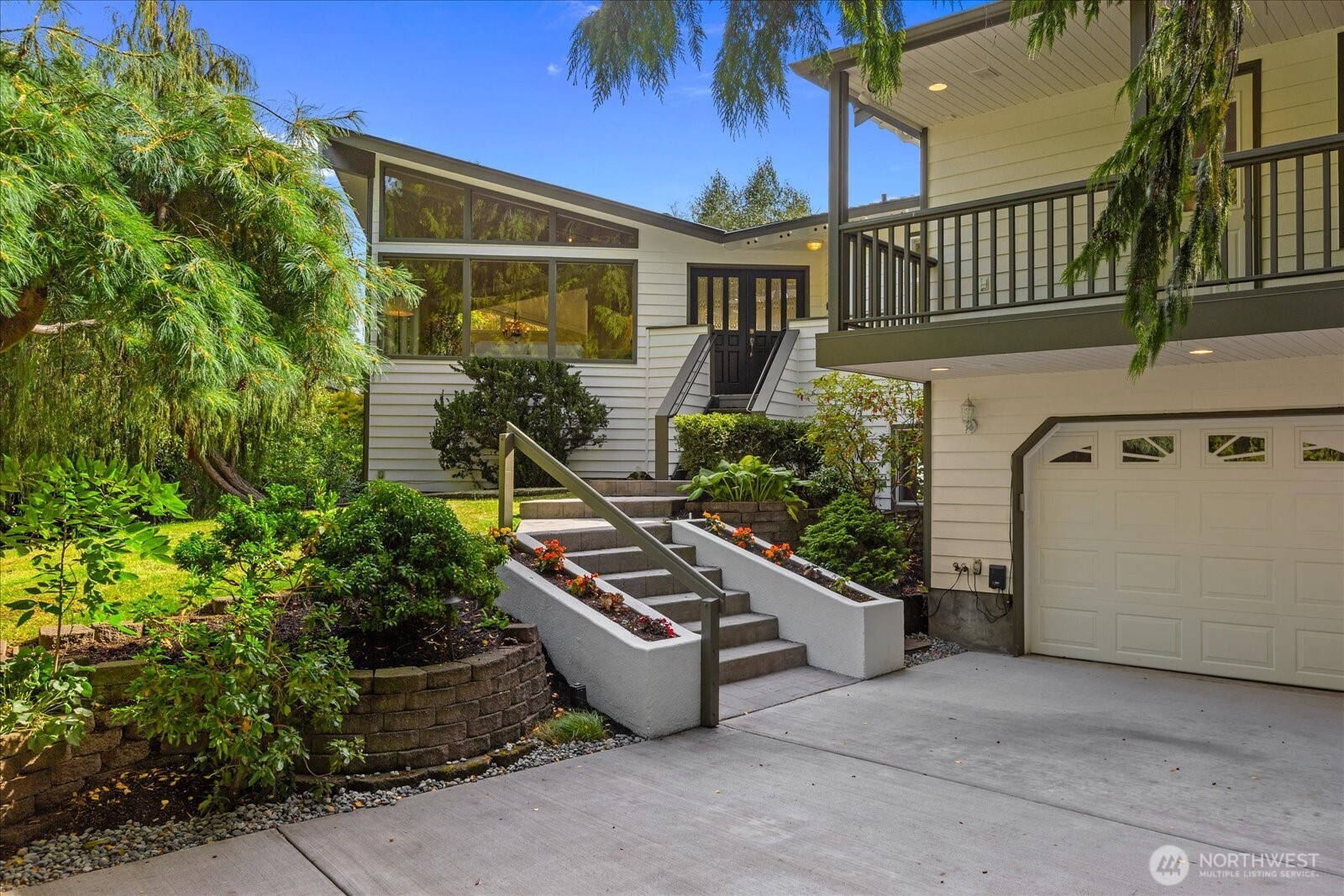 Welcome home to one of Edmonds' most desirable neighborhoods! Set back from a quiet street on a beautifully landscaped .3-acre property, this approximately 4,500 sq ft home is surrounded by mature trees and thoughtfully designed gardens. Northstream winds through the northern portion of the property, creating a tranquil, year-round ambiance and a peaceful connection to nature. Inside, newly updated interior paint and refinished maple hardwood floors bring a fresh, polished feel to the home. Soaring cathedral ceilings, an open floor plan, and an inviting kitchen create an ideal setting for entertaining or relaxing by the fireplace. Step outside to the expansive deck, perfectly suited for gatherings, outdoor dining, or simply enjoying the lovely rose garden and serene surroundings. The spacious primary suite offers dual closets, a private deck, wet bar, and gas fireplace - a peaceful retreat at the end of the day. Downstairs, a two-bedroom attached accessory dwelling unit (ADU) offers exceptional flexibility and has been successfully operated as an Airbnb, Willow Springs Retreat, for four years. More recently, it has been used as a short-term rental generating $3,200/month. Ideal for multi-generational living, guests, additional living space, or potential rental income. Additional spaces include a studio/office and media room, offering room to work, create, relax, or entertain. Outside, the property continues to shine with chicken coop, greenhouse, and established garden spaces