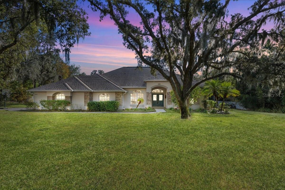 NO HOA • 1 FULL ACRE • RESORT POOL THAT WILL RUIN EVERY OTHER BACKYARD FOR YOU5-bed | 2.5-bath | 3,182 sq ft pool home on a private, one acre lot, with a heated saltwater pool, dramatic grotto, and multiple waterfalls you’ll never want to leave. This isn’t a pool. It’s a daily vacation: Pebble Tec finish + brand-new everything (pump, salt cell, underwater lights) Massive brick-paver lanai, Nighttime light show you control from your phone. Zero rules, zero flood insurance, zero upcoming headaches. All the big stuff already done: • New roof (2021) • Two new ACs (2020 & 2024)  soft start generator-ready, upgraded & oversized whole-house water softener/filtration (2023) • tankless hot water (2023) • new pool equipment (2024–2025)Inside: huge master with pool access + jetted tub, gourmet kitchen with pass-through window to the lanai, luxury vinyl floors, and space for everyone (plus an office/5th bedroom). Minutes to Suncoast Parkway. 40 min to TIA. An hour from the beach.If you want to live at a resort, park your boat or build a massive shop, and never write another HOA check… this is it.Your backyard is waiting. Text or call for your private tour before someone else claims it. See attached feature sheet for full list of updates.