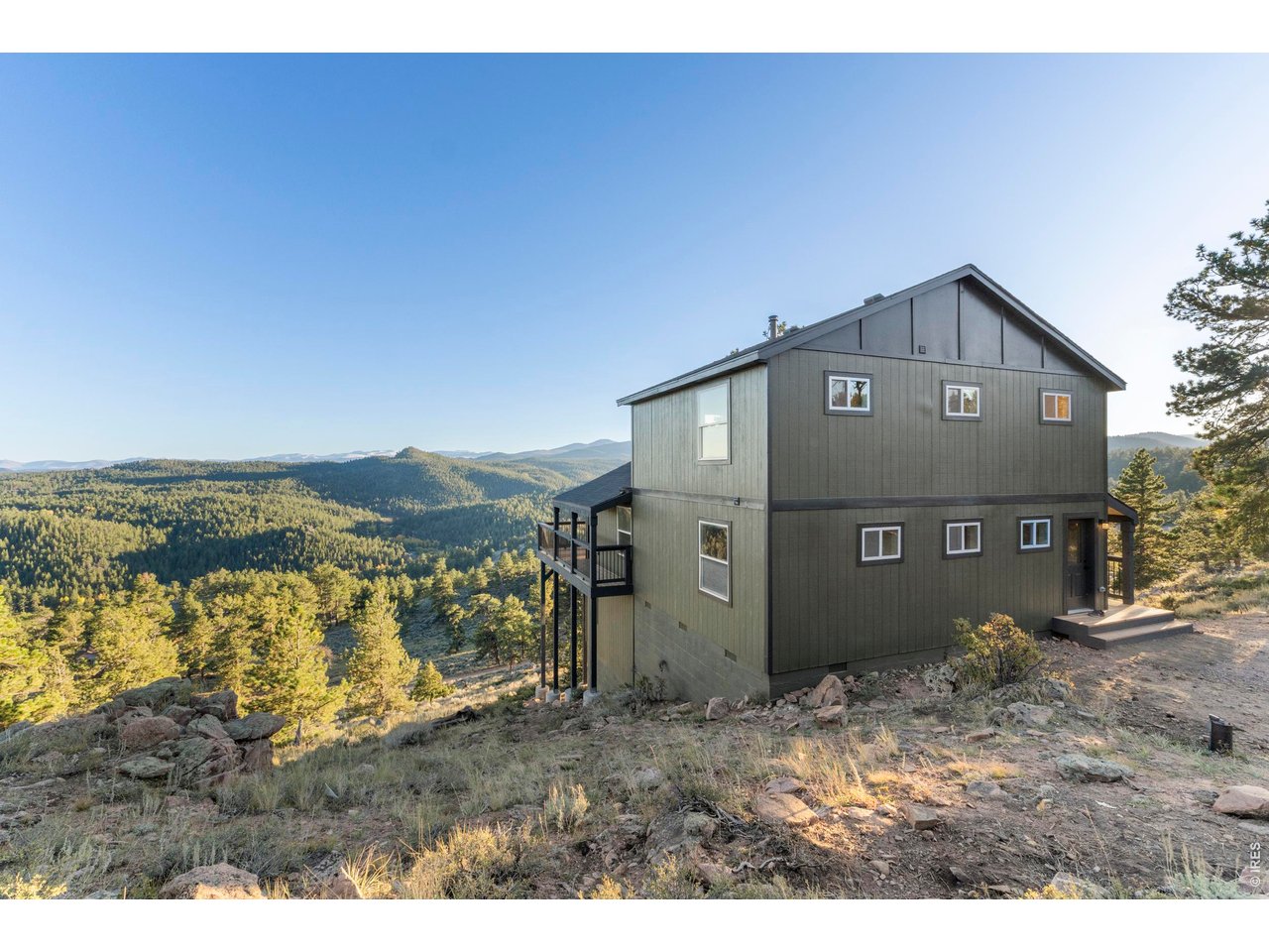 Welcome to your private mountain escape-a beautifully reimagined four-bedroom home set on 5.6 serene acres in scenic Red Feather Lakes. Framed by sweeping panoramic views, this fully rebuilt cabin blends modern convenience with timeless mountain character. Nearly every inch of the home is brand new, featuring high-quality craftsmanship, updated systems, new appliances, and thoughtfully selected finishes throughout. Built with durability in mind, the property offers reliable, year-round access. Inside, the main level features a dramatic great room with vaulted beetle-kill pine ceilings, exposed rustic beams, and a warm, inviting wood-burning stove. A wrap-around deck extends your living space outdoors, offering breathtaking views in every direction-perfect for relaxing or entertaining. The main floor also includes a spacious kitchen, laundry area, full bath, and a comfortable primary bedroom. Upstairs, a loft-style family room provides additional gathering space, along with two bedrooms accented by beetle-kill pine and a beautifully appointed bathroom. The fully finished walk-out basement expands the home even further, offering a large recreation room and a fourth bedroom. Whether you're looking for a full-time residence or a peaceful weekend retreat, this exceptional property offers privacy, tranquility, and the natural beauty of Colorado mountain living.