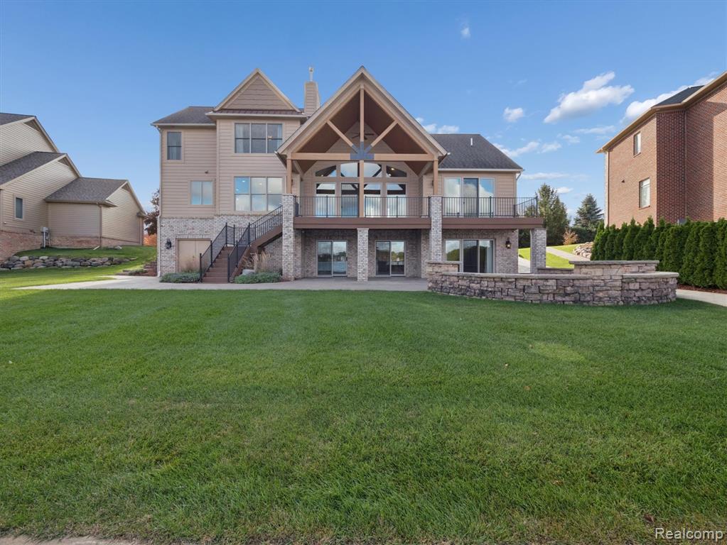 Exceptional lakefront living in this beautifully designed home, located in a private, gated community on the shores of all-sports Loon Lake. With 4,870 sqft of finished space, including a fully finished walkout basement, this home offers breathtaking sunset views. Loon Lake is 243 acres, sandy-bottom, up to 70 ft deep is known for great fishing, slalom skiing & water sports. Gourmet kitchen is a true showpiece, featuring granite countertops, island, reverse osmosis system, high-end stainless-steel appliances, 3 oven spaces, built-in microwave, pull-out drawers & a walk-in pantry—perfect for cooking & entertaining. The main floor offers an open-concept layout anchored by a dual-sided gas fireplace between the great room and dining/kitchen, all overlooking the lake. Spacious office room on main floor next to foyer. First-floor primary suite includes a spa-style walk-in shower, heated floors & generous walk-in closet. Bonus room over garage for additional storage (not included in the square footage) could be finished as 5th bedroom or workout room. Outdoor spaces are designed for relaxation & entertaining, with brick paver patio featuring a fire pit, spacious balcony off the main floor, & a covered patio below—each offering panoramic lake views. Enjoy a natural sandy beach, permanent dock & heavy-duty hoist (included). A paved drive leads down to the shoreline for easy boat launching. The lower level includes a wet bar with fridge, a natural fireplace, two large living areas, plus a second potential primary bedroom with walk-in closet, a full bath with jetted tub & tile shower. Car lovers will appreciate the radiant-heated, insulated three-car garage, complete with slat-wall storage, plastic tile flooring, a car hoist (included or seller can remove) —an ideal setup for collectors or hobbyists.  Here is your complete lakefront lifestyle—luxury, functionality, and unmatched views—all in a highly sought-after gated community. Schedule your showing today!