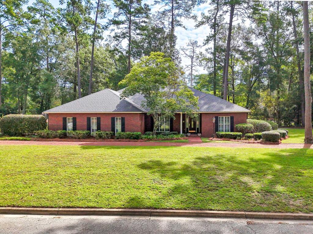 Welcome to 1409 Gordon Avenue, one of Thomasville's favorite in-town neighborhoods convenient to medical care, country club, schools and the bricks of Downtown Thomasville. This brick home includes 4 bedrooms and 3 baths in almost 2780 sf on .83 acres. The one-level floor plan includes large spaces for entertaining family and friends with a formal dining room, formal living room and open kitchen to breakfast room and family room with gas log fireplace. The master bedroom suite is a private retreat complete with a large bathroom and walk-in closet. The split plan has 2 bedrooms connected by a Jack and Jill style bathroom plus an additional bedroom with an ensuite bath. Access the oversized covered deck from the kitchen/breakfast area which has built-in seating and storage cabinets. Don't miss the additional storage in the 2 car garage and a manicured yard has abundant full size shrubs and trees. This is your chance to have the perfect in-town location. Call today to schedule your appointment.