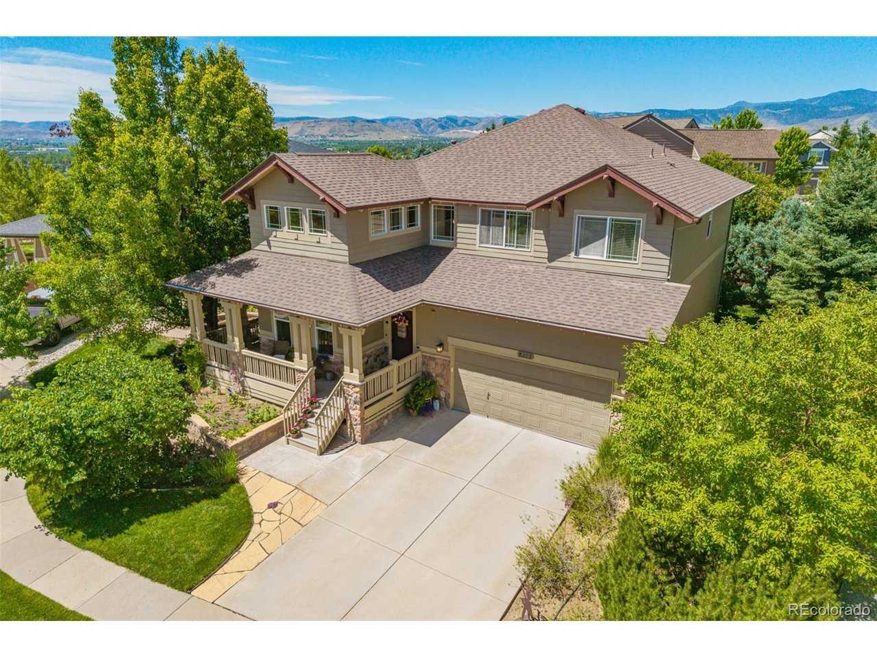 Exceptional new listing in the popular Village of Five Parks neighborhood in West Arvada! This stunning two story home offers 2513 finished square feet, 3 bedrooms, 3 bathrooms and has been lovingly maintained by the original owners! As you arrive, you are greeted by lush mature landscaping with gorgeous flower beds and an inviting wrap around front porch! This beautifully designed home welcomes you with gleaming hardwood floors and dramatic soaring ceilings! Abundant natural light fills this home, creating a bright, open and airy atmosphere w neutral colors! Spacious living room & dining room offers ample space for family gatherings, entertaining guests and special occasions.  Large eat-in kitchen with granite countertops, built-in desk area, pantry, and a center island for additional seating. The family room has surround sound and a cozy gas fireplace. Impressive primary suite with mountain views, a lovely sitting area, elegant crown molding, and a sizeable walk-in closet!  The en-suite 5 piece bathroom features double sinks, oversized shower, and a soaking tub.  The laundry room is located on the main level and includes a utility sink and cabinets for extra storage.  Two additional bedrooms are located on the upper level as well as a full bathroom and a versatile loft featuring built-in desk space. Amazing private, serene backyard with a flagstone patio, fire-pit, and a pergola with a decorative metal canopy, perfect for summer barbeques and outdoor enjoyment. Flagstone steps grace both sides of the home, accented by lush shrubs and colorful blooms! Three car tandem garage with built-in storage for your tools and gear.  The unfinished basement presents endless possibilities for expansion including additional bedrooms, bath, rec area or fitness space!  This superb location & vibrant community is minutes away from neighborhood playgrounds, multiple parks, clubhouse, pool, fitness area, tennis courts, schools, and restaurants!  This is Colorado living at its finest!