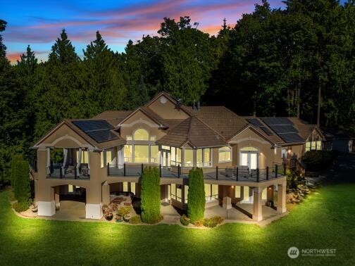 Perfectly positioned between 2 world class cities, approximately 50 miles north to Vancouver BC & 50 miles south to Seattle. East facing 5 acre retreat in a gated community on pristine Lake McMurray waterfront. 269 feet of private lake frontage w space for a future dock creates a rare lakefront estate offering privacy, nature, wildlife & comfort for buyers seeking a peaceful off the grid lifestyle w convenience to Mount Vernon, Arlington, Smokey Point, Hwy 9 & the I 5 corridor. Main level living w daylight basement in this nearly 4996 square foot residence designed for multi generational living or extended stays. The main floor features a primary suite w fireplace, spa inspired bath, dual walk in closets, private en suite bedroom ideal as a junior suite & large laundry room, all opening to the deck overlooking the lake. The chefs kitchen w quartz & granite surfaces, premium Dacor refrigerator & generous storage flows into vaulted living spaces w fireplace & sweeping lake & territorial views. The lower level offers 3 bedrooms, Jack & Jill bath, flex room & a spacious rec room w wet bar, wine closet, fireplace & access to a covered patio & lawn leading to the water plus a 1000 square foot insulated storage area. A tree lined pond w gazebo, waterfall, fountain & koi enhances the estate. Features include community dock w boat launch, 40 solar panels, new HVAC, 1000 gallon propane tank, Sonos sound & generator system supporting a self sufficient lifestyle.