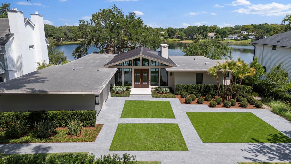 Wonderfully executed remodel of a classic mid-century modern residence with an elevated view overlooking scenic Lake Sylvan. This home was restored beautifully and now with up-to-date amenities including provisions for home automation, current kitchen and baths, pool, outdoor living, and finished off with Signature Landscape Contractors hardscape and landscape to complete the vision well executed by Floridian Homes!