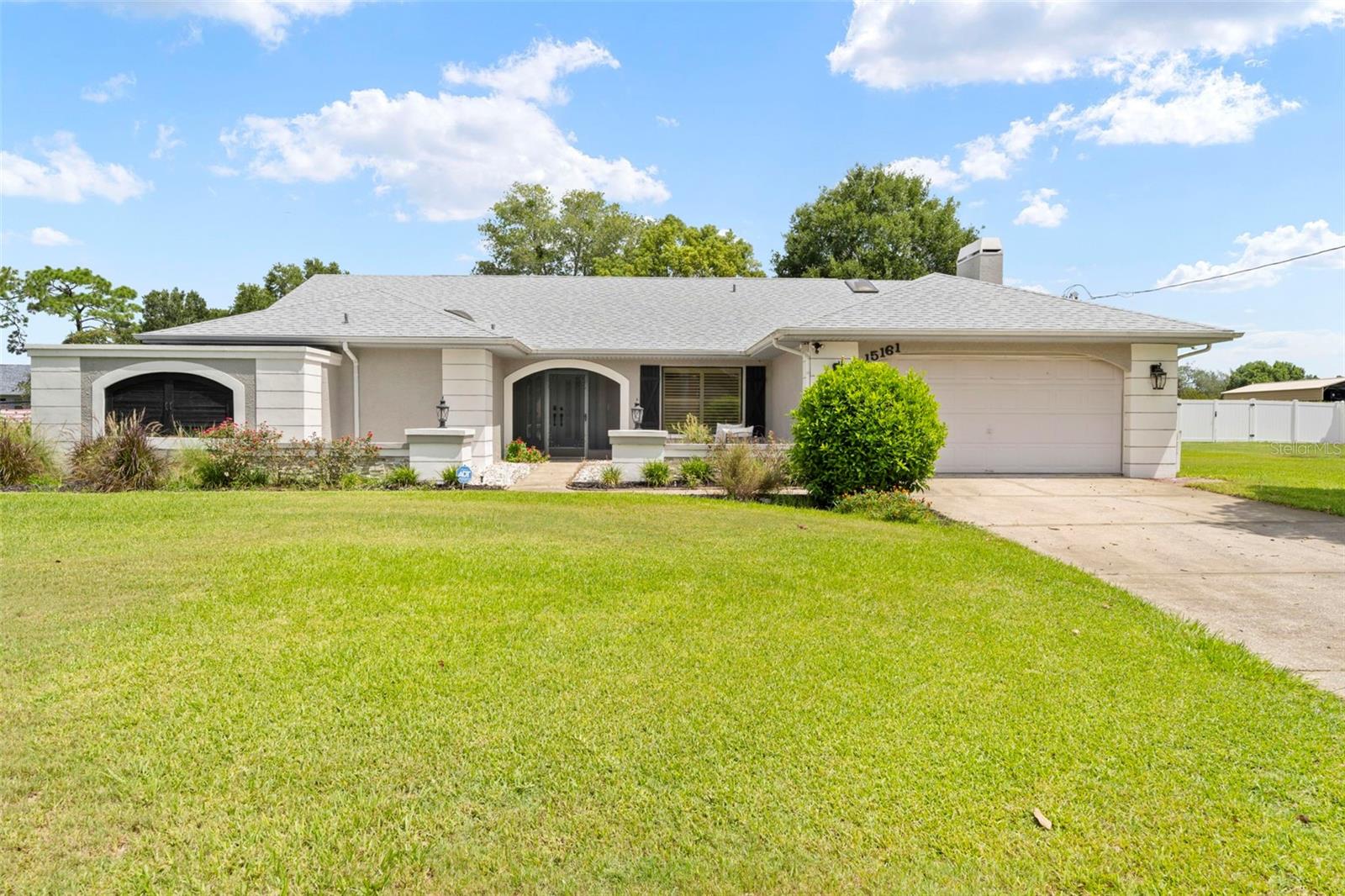 Welcome to Woodbury Road, where comfort, charm, and thoughtful updates come together in this beautifully maintained 3-bedroom, 2.5-bathroom pool home with a 2-car garage and 2,012 square feet of living space. Enjoy peace of mind with a new roof installed in 2022 and a layout designed for both relaxation and entertaining.

As you enter through the double door entry, you're welcomed into a spacious living and dining room combination, with the formal dining area to the right—perfect for hosting gatherings. The living room features sliding glass doors that provide an immediate and inviting view of the screened-in pool area, setting the tone for the Florida lifestyle from the moment you step inside. This home is adorned with elegant plantation shutters throughout, including on the sliding glass doors, offering both style and privacy.

To the left of the living room is the master suite, a private retreat featuring sliding glass doors to the lanai, plantation shutters, walk-in closets, and a luxurious en suite bathroom. The master bath boasts dual sinks with stone countertops, wooden cabinetry, tile flooring, a fully tiled walk-in shower, and a relaxing sunken garden tub.

At the heart of the home is a well-appointed kitchen showcasing solid wood cabinetry, granite countertops, stainless steel appliances, and tile flooring. A breakfast bar with seating for three opens directly to the cozy family room, which features a beautiful fireplace and plush carpeted flooring—an ideal space for casual gatherings. Sliding glass doors from both the kitchen and family room lead out to the covered lanai, offering a seamless indoor-outdoor flow.

The lanai features an in-ground pool with a full pool cage, cabinetry with a sink, and electrical hookups ready for a future cooktop. Just beyond the screened lanai, you'll find a paver patio with a hot tub, perfect for relaxing evenings.

Just off the family room, a hallway leads to the guest bathroom, located on the left, offering direct access to the pool. This bathroom has been tastefully updated with a dual sink wooden vanity, tile flooring, and a walk-in tiled shower with sliding glass doors. Across the hall, the indoor laundry room includes a deep sink, storage cabinetry, and a commode for added convenience.

Further down the hall is the second guest bedroom with a standard closet, carpeted flooring, and pocket doors that open into the third bedroom, which features its own standard closet and sliding glass doors to the pool. This unique layout offers the flexibility to combine both rooms into one large suite or spacious bedroom—perfect for guests, multigenerational living, or a home office.

Additional highlights include a well for irrigation, roll-up hurricane shutters for peace of mind, and mature landscaping surrounding the home. Located in Spring Wood Estates, this property places you just minutes from the Suncoast Parkway (589) and close to most major shopping, including Target, Kohl’s, Publix, and so much more.

This home offers the perfect blend of privacy, functionality, and Florida lifestyle—set your appointment today!