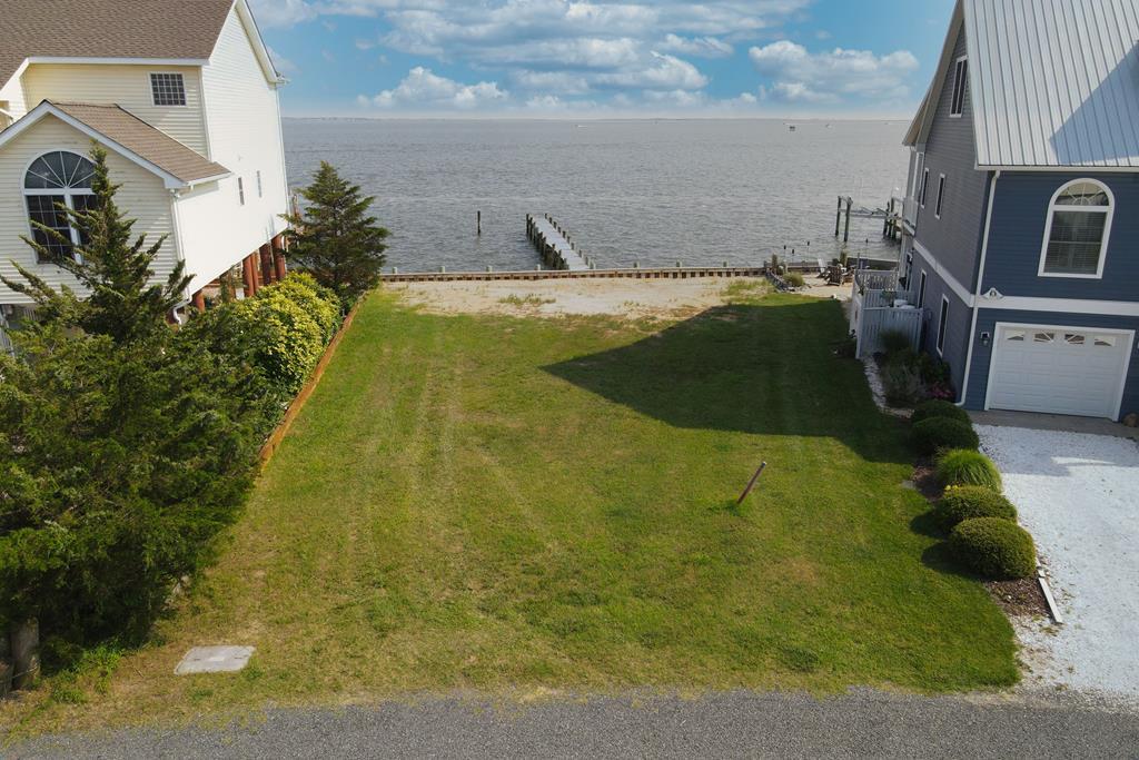 3/1319 Direct Bay Front lot with approximately 65' of vinyl bulkhead & 70' Pier on Virginias notorious Chincoteague Bay.  Just imagine the Chincoteague Bay as your back yard! Unlimited water views and water sports for the whole family to enjoy such as, crabbing, fishing boating, the possibilities are endless and don;t forget the rocket launches!  A perfect place to build your dream home or vacation home.  Captains Cove is the fastest growing Golf & Waterfront Community located on the Eastern Shore of Virginia, close to Chincoteague Island, Wallops Island and Ocean City MD. HOA amenities: Pristine 9 Hole Golf Course, indoor/outdoor pools (2), fitness center, pickle-ball & basketball courts, playground, Picnic area, boat ramp, biking & walking trails, dog park, security and more.