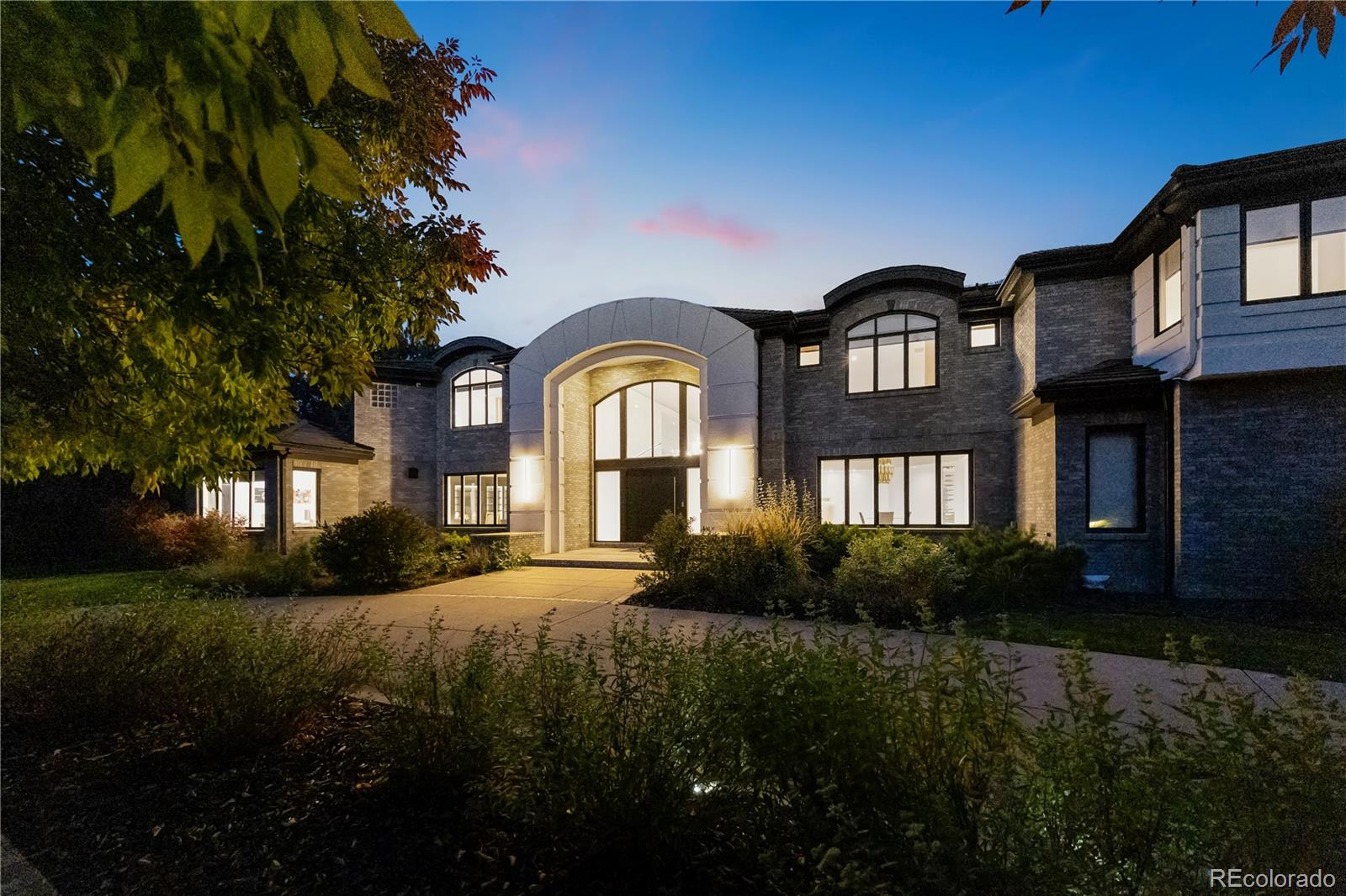 An exceptional estate in Cherry Hills Farm blending timeless elegance with modern sophistication. Recently reimagined, this over 16,000 sq ft residence delivers an unmatched living experience on a private cul-de-sac.A circular driveway and manicured grounds lead to a dramatic entry featuring a dual glass Imperial staircase beneath soaring 30+ foot ceilings. Light-filled great rooms showcase floor-to-ceiling windows, sleek porcelain-encased fireplaces, and an effortless flow ideal for everyday living and grand entertaining.The main level offers a custom wet bar with illuminated displays and aquarium centerpiece, soundproof theater with tiered seating, glass-enclosed wine cellar with automated dispenser, and an entertainment wing with golf simulator and lounge. The chef’s kitchen boasts dual Dekton islands, Wolf and Sub-Zero appliances, built-in coffee station, butler’s pantry, and seamless indoor-outdoor connection.Upstairs, the primary suite offers a private balcony, fireplace, spa-inspired bath with double walk-in shower, soaking tub with water feature, and boutique-style dressing room with custom lighting and sound. Five additional ensuite bedrooms provide private retreats with luxury finishes.Additional highlights include an attached apartment with private entrance and full kitchen, two home offices, upper-level fitness studio with ensuite bath, finished lower level with game room, art room, and abundant storage. A Savant smart-home system, automated shades, nine heating/cooling zones, owned solar panels offsetting 140% of energy costs, and advanced security with cameras enhance the property.Set on nearly an acre with mature trees and manicured landscaping, the estate offers both a serene retreat and entertainer’s dream.