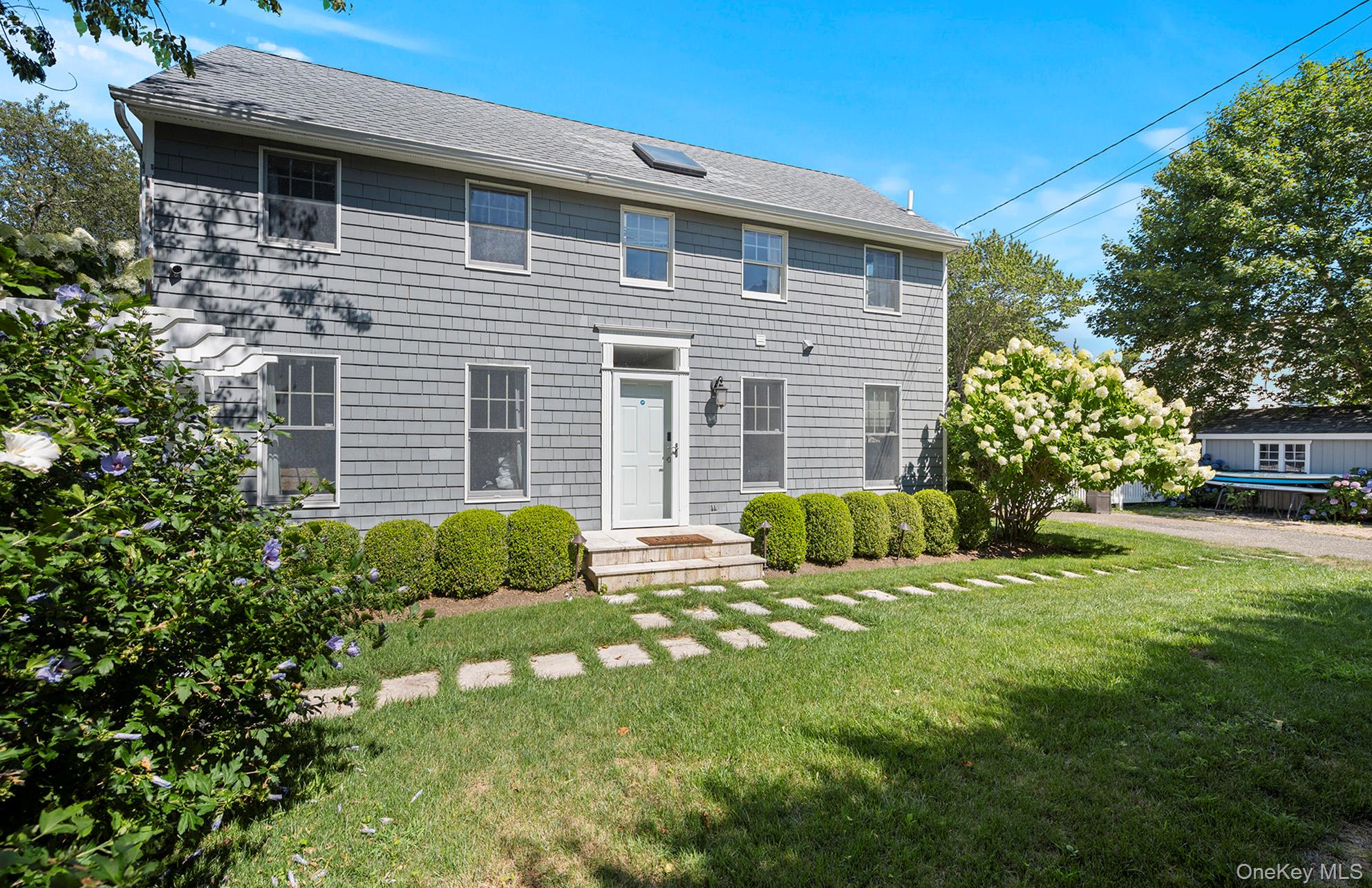 Stunning Modern Retreat in Bay Point
Spend your downtime in style at this beautifully renovated 4-bedroom, 3-bathroom modern home located in the sought-after waterfront enclave of Bay Point. Just moments from Foster Memorial Beach and only 1.5 miles from Sag Harbor Village, this residence offers the perfect balance of contemporary comfort and timeless Hamptons charm. Step inside to a sunlit open concept living space featuring soaring cathedral ceilings and skylights that bathe the interior in natural light. The gourmet kitchen is a chef's dream, outfitted with premium stainless-steel appliances-including a Bertazzoni range-white quartz countertops, a farmhouse sink, and elegant grey, beige, and white finishes throughout. The main-level primary suite boasts its own private entrance and sliding barn doors for added privacy. Upstairs, two guest bedrooms share a stylishly appointed full bathroom with upscale finishes and raindrop showerheads. The fully finished lower level is ideal for entertaining, offering a spacious media lounge, a wet bar, a fourth bedroom, and an additional full bath with a glass walk-in shower and designer tilework. Outdoors, enjoy your own private oasis with a beautifully landscaped yard, a 20' x 40' heated in-ground pool, an outdoor shower, and multiple areas for lounging or dining al fresco. Conveniently located near Serene Green Organic Farmstand and just minutes to the beach, this home offers tranquility, convenience, and the very best of Hamptons living-including those unforgettable west-facing sunsets just down the road.
