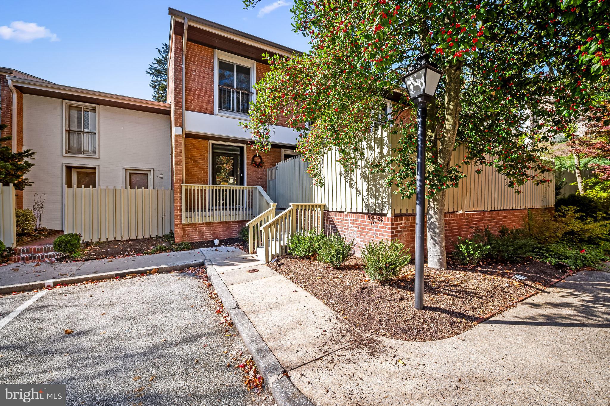 There is nothing left to do but unpack your bags and enjoy this handsome renovation.   This 23' wide townhome with oversized, enclosed back patio is the perfect place to watch the sun set.  It is flooded with afternoon sunlight.  The spacious living room has a fireplace flanked by bookshelves, and there are bookshelves along the other wall, so its perfect for collectors and scholars.  All three baths have been stylishly renovated  and the spacious kitchen has newer stainless steel appliances, quartz countertops and extra storage space.  Walk out to the front brick enclosed patio from your kitchen.  The windows and sliding doors have all been replaced and have attractive, light filtering window treatments.  The washer / dryer has been moved upstairs for your convenience.  Lots of storage throughout the home & custom closets throughout.  There is extra storage in the lower level, a designated parking space and  a recent roof and sewer line.  Move into Cross Keys in time to enjoy the holiday festivities in the lively village with many dining options and interesting boutiques.   The pools and tennis / pickleball court make for enjoyable summer living.   One of the best locations in all of Baltimore City.