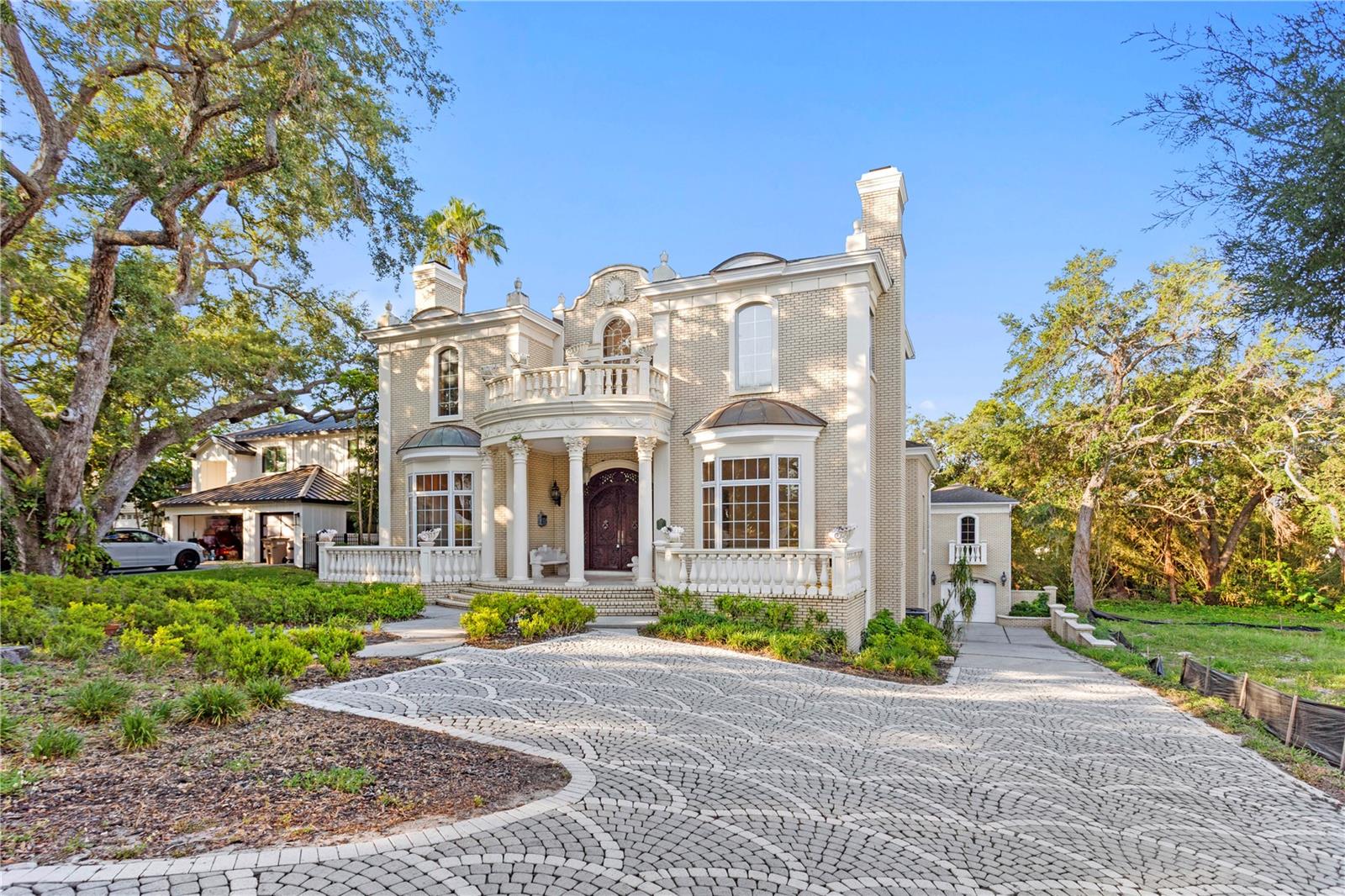 One or more photo(s) has been virtually staged. Grand Belleair Estate – European Elegance, Endless Potential!!
Step into timeless elegance with this over 6,000 square foot masterpiece, gracefully situated on an **almost half-acre lot** in one of Belleair’s most sought after neighborhoods. Featuring six spacious bedrooms and five and a half bathrooms, this estate offers a rare opportunity for those seeking a luxurious blank canvas — ready to personalize while embracing its opulent European-inspired interiors.

Designed with influences from the Baroque, Rococo, and Neoclassical eras, the home's intricate moldings, soaring coffered ceilings, detailed woodwork, and lavish finishes create an ambiance reminiscent of a European palace. Whether you are drawn to the romantic grandeur or envision blending classic beauty with contemporary upgrades, this estate invites your imagination.

The main residence features a grand two-story formal living room adorned with custom architectural details, an elegant formal dining room perfect for entertaining, and multiple living spaces designed for both comfort and sophistication. The chef’s kitchen is appointed with premium **Wolf appliances**, offering the perfect canvas for culinary creativity. Nearby, relaxed dining and family areas flow seamlessly for everyday living.

The private first-floor primary suite serves as a luxurious retreat, complete with expansive closets and a spa-inspired bathroom featuring a **steam room** — your own personal wellness sanctuary. Guest bedrooms throughout the home are generously sized, providing comfort and privacy for family and visitors alike.

Adding even greater flexibility, a fully equipped one-bedroom, one-bathroom **guest suite** with its own **private entrance** is perfect for visiting friends, extended family, or in-law stays — offering both independence and connection under one roof.

The expansive backyard, enhanced by the nearly half-acre lot, provides the perfect setting to design a show-stopping **custom infinity pool** overlooking a peaceful stream. Covered patios, lush mature landscaping, and the serene natural surroundings create an extraordinary outdoor living experience.

Practical upgrades ensure peace of mind and modern comfort, including **four separate AC units** (three updated in **2021 and 2022**, and one original from 1995) along with **two hot water heaters** installed in **2018** and **2022**. Roof is 2019 main house and 2015 ADU. 

Located in the heart of Belleair, this grand estate places you just minutes from world-class golf courses, boutique shopping, fine dining, and the powdery sands of Florida’s Gulf Coast beaches.

A true canvas of opportunity, 1577 Alexander Road blends timeless European artistry with modern luxury and endless potential. Homes of this scale, character, and flexibility rarely come available — this is your chance to create something truly extraordinary.