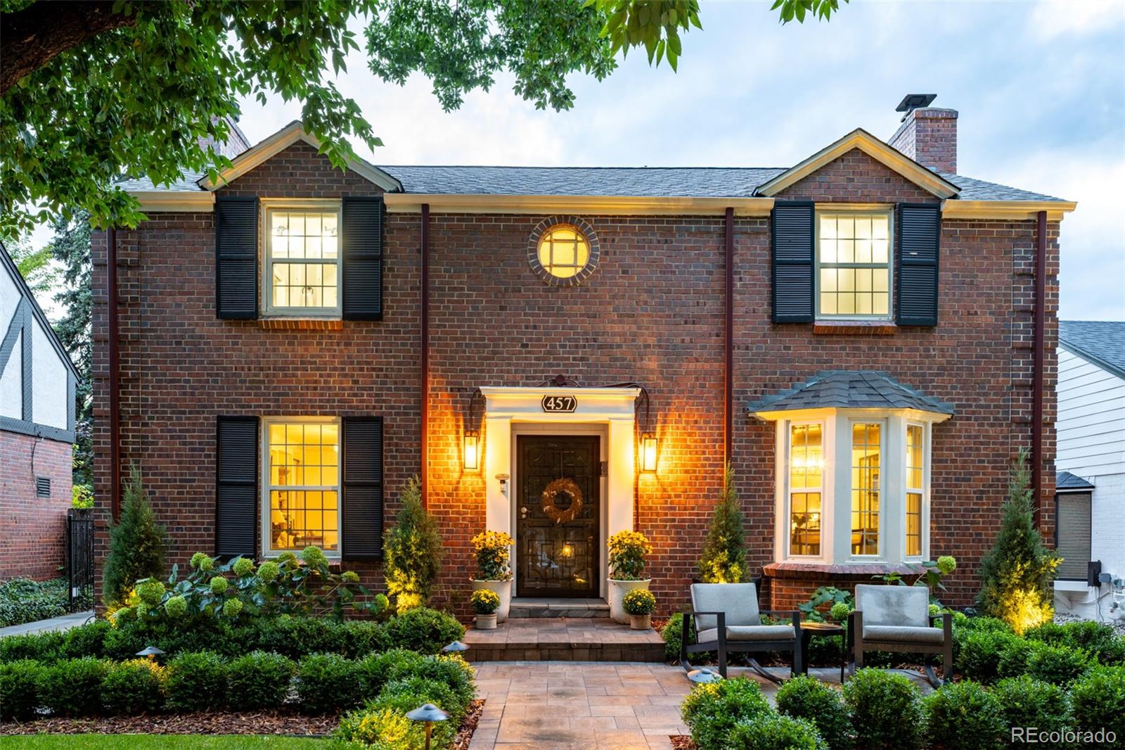 Coming Soon! Ideally located and refined, this updated two-story Hilltop residence sits on a beautiful, tree-lined block in one of Denver’s most desirable neighborhoods. Enjoy exceptional walkability to Robinson Park, the 9+Co shops and restaurants, and the Denver Tennis Club, with effortless five-minute access to Cherry Creek and Lowry’s premier dining, shopping, and entertainment.The inviting exterior is enhanced by professionally designed landscaping with custom architectural and landscape lighting, creating striking curb appeal and a seamless connection between indoor and outdoor living day or night. Inside, a dramatic central staircase crowned by skylights floods the home with abundant natural light. The spacious living room features a classic fireplace flanked by custom built-in shelving, offering the perfect backdrop for a curated relaxed time at home. A light-filled dining room, anchored by a contemporary fixture and bay window, flows gracefully into a pristine kitchen with crisp white cabinetry, stainless steel appliances, and a peninsula with seating.The upper level offers three well-appointed bedrooms and two full bathrooms. The primary suite is a true retreat, complete with a  walk-in closet and a spa-like bath featuring a large walk-in shower. The additional bathroom has been tastefully updated with modern fixtures and finishes.The finished lower level provides exceptional flexibility, featuring a statement fireplace, custom built-in bar, and a private guest suite and bathroom, ideal for visitors or extended stays. Outdoors, a covered patio overlooks a spacious backyard with a fire pit and custom landscape lighting, 2 Car Garage, and gated driveway—perfect for enjoying Colorado’s outdoor lifestyle year-round.Additional highlights include a newer furnace (2022), along with a six-year-old roof (2020), offering comfort and peace of mind in this truly exceptional Hilltop home.