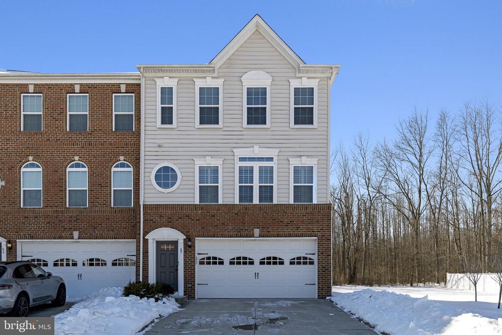 Welcome to 87 Isabelle Court, a beautiful end-unit townhome located in one of Marlton’s most desirable neighborhoods. Offering approximately 2,800 square feet of living space, this spacious home delivers exceptional value, abundant natural light, and modern construction built in 2016—meaning the roof, mechanicals, and major systems are well within their life expectancy. The end-unit location provides extra windows and enhanced sunlight throughout the home. The first floor features a large living area perfect for entertaining or relaxing, along with a convenient half bathroom. It also houses the mechanical systems. The home is beautifully decorated and shows pride of ownership at every turn. The second floor boasts an impressive open-concept layout, including a spacious living room, a large eat-in kitchen with dining area, and an additional bonus space ideal for hosting gatherings with a long dining table. The kitchen is highlighted by recessed lighting, stainless steel appliances, granite countertops, and a stunning 8-foot island, making it the heart of the home. Hardwood floors run through most of the residence, adding warmth and elegance. Just off the second level, step outside onto a large private deck overlooking peaceful wooded views—perfect for morning coffee or evening unwinding. The third floor offers three generously sized bedrooms, a full hall bathroom, a conveniently located laundry room, and a luxurious primary suite featuring vaulted ceilings, a walk-in closet, and ample space to retreat at the end of the day. The entire third floor showcases brand-new hardwood flooring. This is a rare opportunity to own a spacious, modern townhome in a prestigious Marlton community—offering comfort, style, and tremendous value for the price. Don’t miss it.