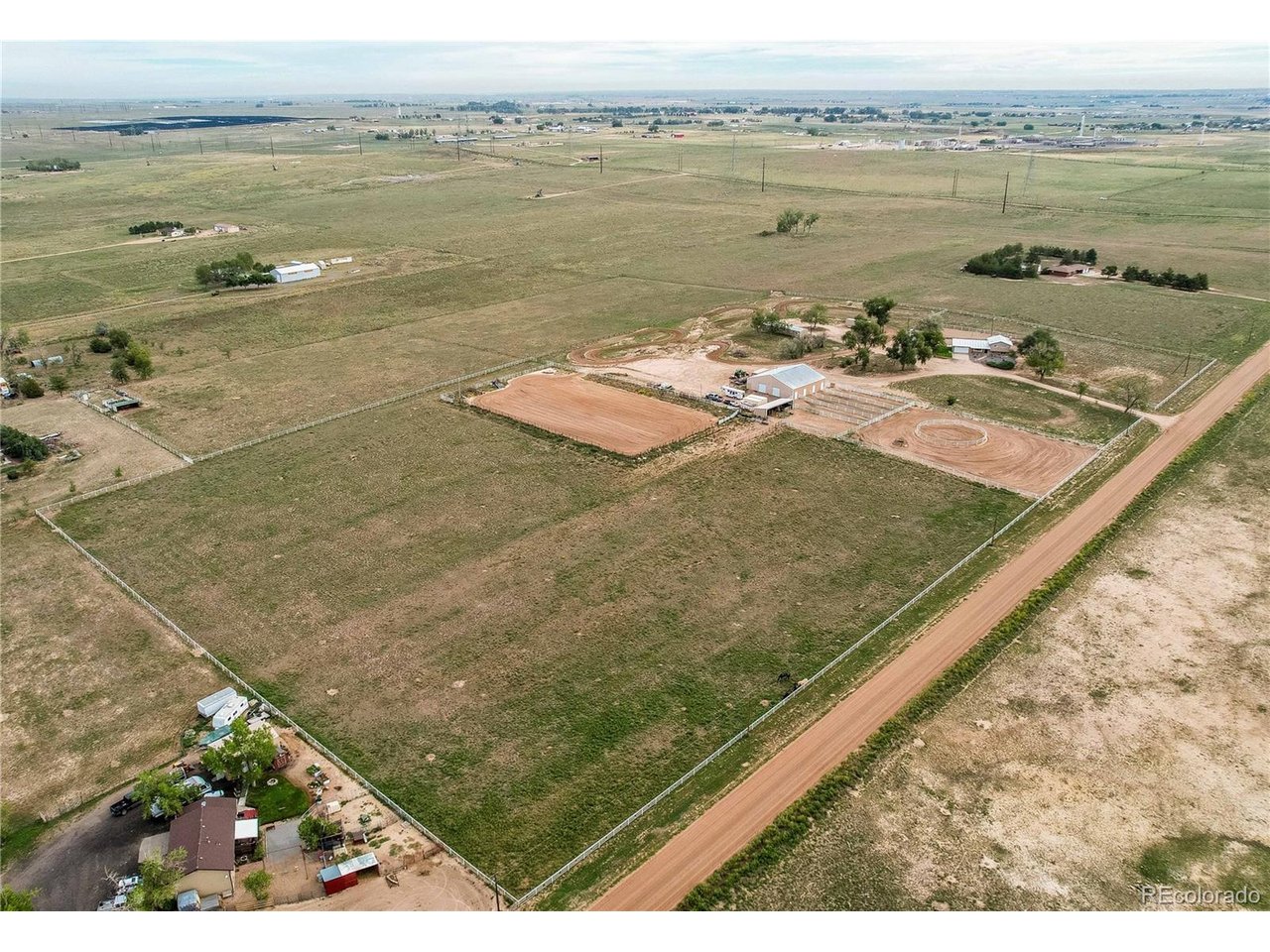 Bring Your Horses: 15.89 Acres Near Fort Lupton with Arena, Barn, Shop & Full Front Range Views. Rope, ride and work on this horse property with a 150x300 roping arena, a 30x60 heated shop, full Front Range mountain views and no HOA. The 30x60 barn has four oversized 15x15 stalls with individual waterers, electricity, tack room and hay storage. The riding/roping arena features a return alley and chutes, complemented by a 50-ft round pen, corral, pipe-fenced runs, a loafing shed with runs and fenced pasture. The separate 30x60 heated and insulated shop (1,800 sq ft) has 220V power, water and a concrete floor, with room for trucks, trailers, equipment and projects. The remodeled 3-bed, 3-bath, 1,854 sq ft home sits on top of the hill to take in the views, with a custom kitchen, stainless appliances, fresh paint, double-pane windows, metal roof and a new septic system installed July 2025. Extras include a 2-car attached garage, motorcycle track and detached mobile home for additional living space. Agricultural zoning in unincorporated Weld County, private well, county-maintained road, Weld County RE-8 schools. AI was used in editing and photos.