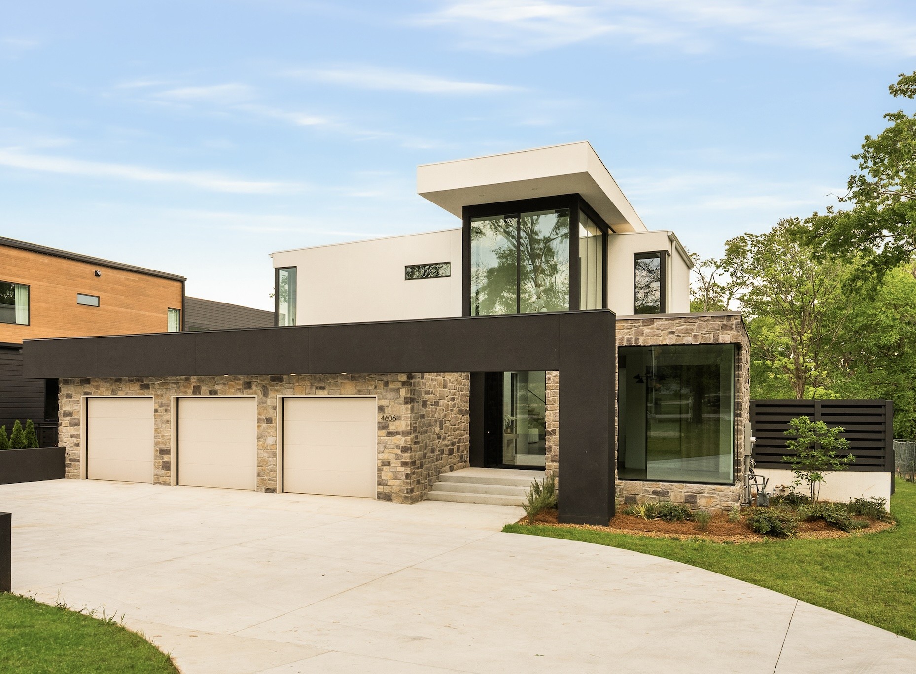 A dramatic 20-foot entry sets the tone for a home where design isn’t just seen, it’s felt. Frameless Dayoris doors, custom LuxView windows and sliders, and a layered palette of refined finishes strike that rare balance: clean, but never cold. Architectural moments like the floating staircase and sculptural stone feature wall anchor the space and give it a distinct point of view. Every element feels considered, cohesive, and elevated. Powered by Control4, the home adapts to you, custom lighting scenes, seamless integration, and prewiring for automated shades already in place. Modern living, fully realized. A true showpiece kitchen blends form and function with hidden storage walls, an oversized butler’s pantry, and a layout designed for both everyday living and effortless hosting. The transition to outdoors is seamless, opening to a private terrace, pool, and spa that reads more like a boutique hotel than a backyard. All of it, just minutes to Green Hills, I-40, and Downtown Nashville.