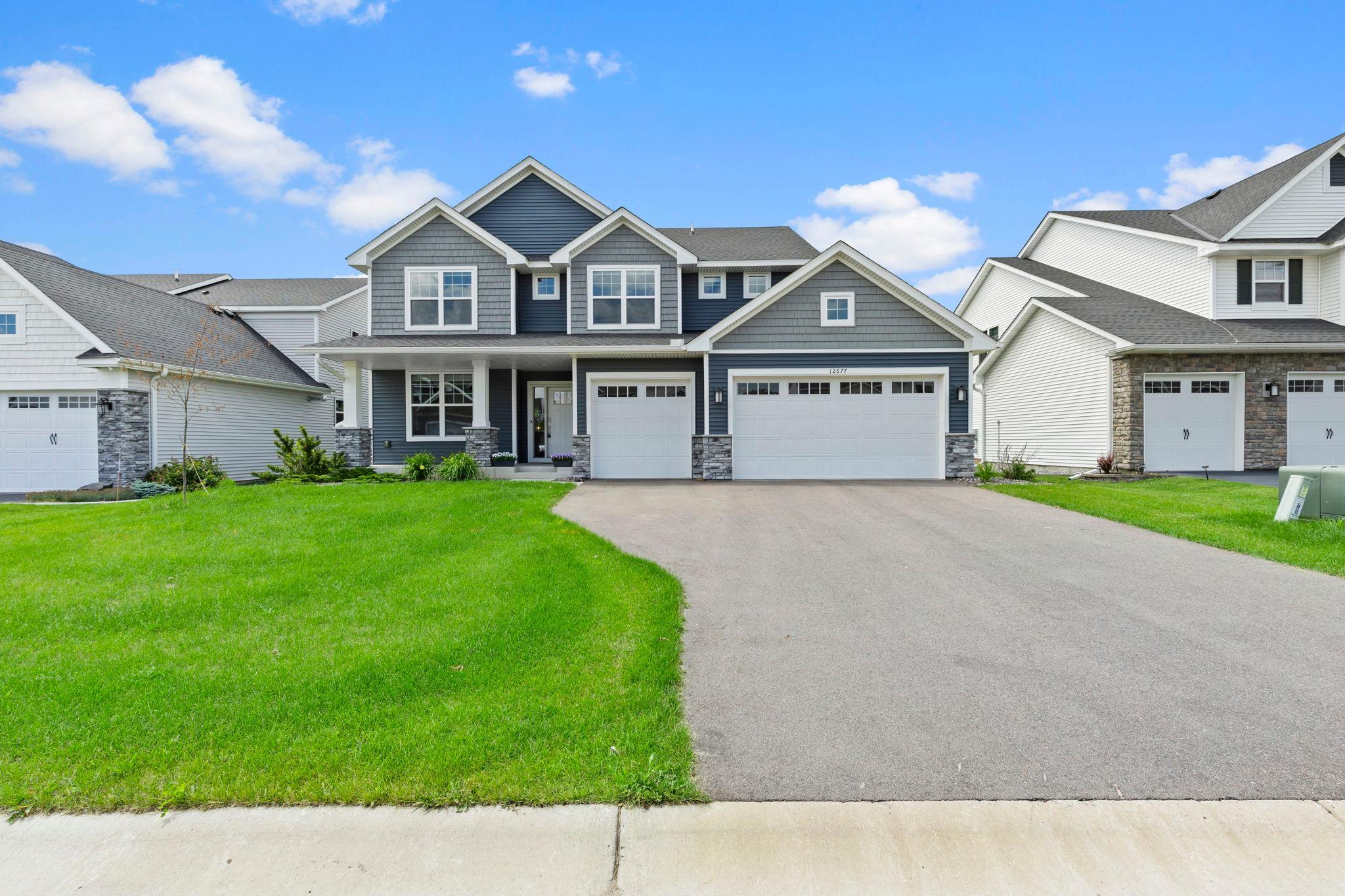 Welcome to this stunning five bedroom, three bathroom two story home built in 2023, ideally located in the desirable Meadow Ridge neighborhood of Rosemount near parks, trails, shopping, restaurants, and everyday conveniences. The main level features an open concept layout with luxury plank flooring throughout and a chef inspired kitchen with quartz countertops, a large center island with breakfast bar seating, stainless steel appliances, a gas cooktop with vent hood, abundant cabinetry, and a spacious walk in pantry. The kitchen flows seamlessly into the informal dining area with sliding glass doors leading to the backyard, perfect for entertaining. The inviting living room offers a gas fireplace with a beautiful mantel and oversized windows providing abundant natural light. The main level also includes a front facing bedroom with a nearby three quarter bathroom featuring a walk in shower, along with a mudroom entry from the insulated two car garage and a walk in closet for convenient storage and organization. The upper level features four generously sized bedrooms, including a spacious primary suite with a private bathroom offering dual vanities, a soaking tub, a separate walk in shower, and an impressive walk in closet. Bedrooms two, three, and four all include walk in closets and are located near a full bathroom with dual sinks and a tub and shower combination. A centrally located loft provides additional living space, and the upper level laundry room includes a washer and dryer, utility sink, and shelving. The unfinished lower level offers excellent potential for future expansion, allowing for additional living space, bedrooms, or recreational areas. This beautifully designed home combines modern finishes, thoughtful functionality, and an excellent location in one of Rosemount’s most sought after neighborhoods.