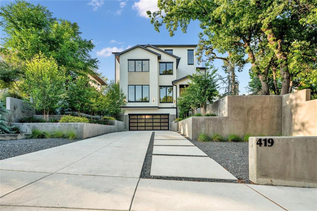 Elevated elegance in East Kessler. Nestled in the highly sought-after East Kessler community, this meticulously crafted new build by Kessler Hill Custom Homes delivers luxury, architectural precision, and serenity on one of the neighborhood’s most exclusive hillside streets. Built on an elevated lot with pier-and-beam construction, reinforced concrete retaining walls, and professionally designed landscaping, the home combines enduring strength with dramatic curb appeal. Inside, a soaring 20-foot-ceiling living room with white-oak floors and floor-to-ceiling windows sets a tone of light and sophistication. The gourmet kitchen features a massive quartzite island, commercial-grade range, and a custom butler’s pantry ideal for entertaining. An elevator connects all levels, including a second-floor lounge with two ensuite bedrooms and a terrace showcasing iconic Dallas views. The top floor offers a flexible multi-purpose suite with a built-in bar — perfect for media, game, or guest use. The primary suite on the main level is a private retreat overlooking the pool and treetops, complete with a sitting area, spa-inspired bath with dual vanities, soaking tub, and custom walk-in closet. The outdoor living space is a showpiece — a lush, elevated courtyard with resort-style pool and mature landscaping that create both intimacy and grandeur. Just a short walk from Kidd Springs Park and minutes from Bishop Arts and Trinity Groves, this home blends the tranquility of hillside living with the energy of urban Dallas.Move-in ready with builder home warranty.