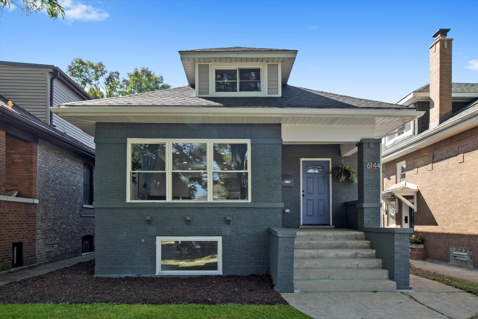 Experience timeless Chicago charm redefined at 6144 N Maplewood Avenue. This quintessential brick bungalow has been fully reimagined with a brand-new gut renovation, blending historic character with contemporary elegance. Situated on a quiet one-way street just two blocks from vibrant Devon Avenue, you'll find yourself walking distance to the city's finest restaurants and cultural destinations. The main level showcases a gourmet chef's kitchen with quartz countertops and two-tone cabinets, two spacious bedrooms, a dedicated mudroom, and a bathroom featuring meticulous tiling and luxury finishes. Upstairs, the master suite spans the entire floor, offering a private retreat with exceptional scale and comfort. The lower level boasts impressive ceiling height, a large family room with a wet bar, 2 oversized bedrooms, and another beautiful full bath, creating versatile living and entertaining spaces. Outdoors, enjoy crisp fall nights on your new patio, paired with the convenience of a brand-new two-car garage. Every detail has been carefully curated, making this residence a rare blend of classic architecture and modern luxury living. Nothing to do but move in and enjoy! Book your showing today.