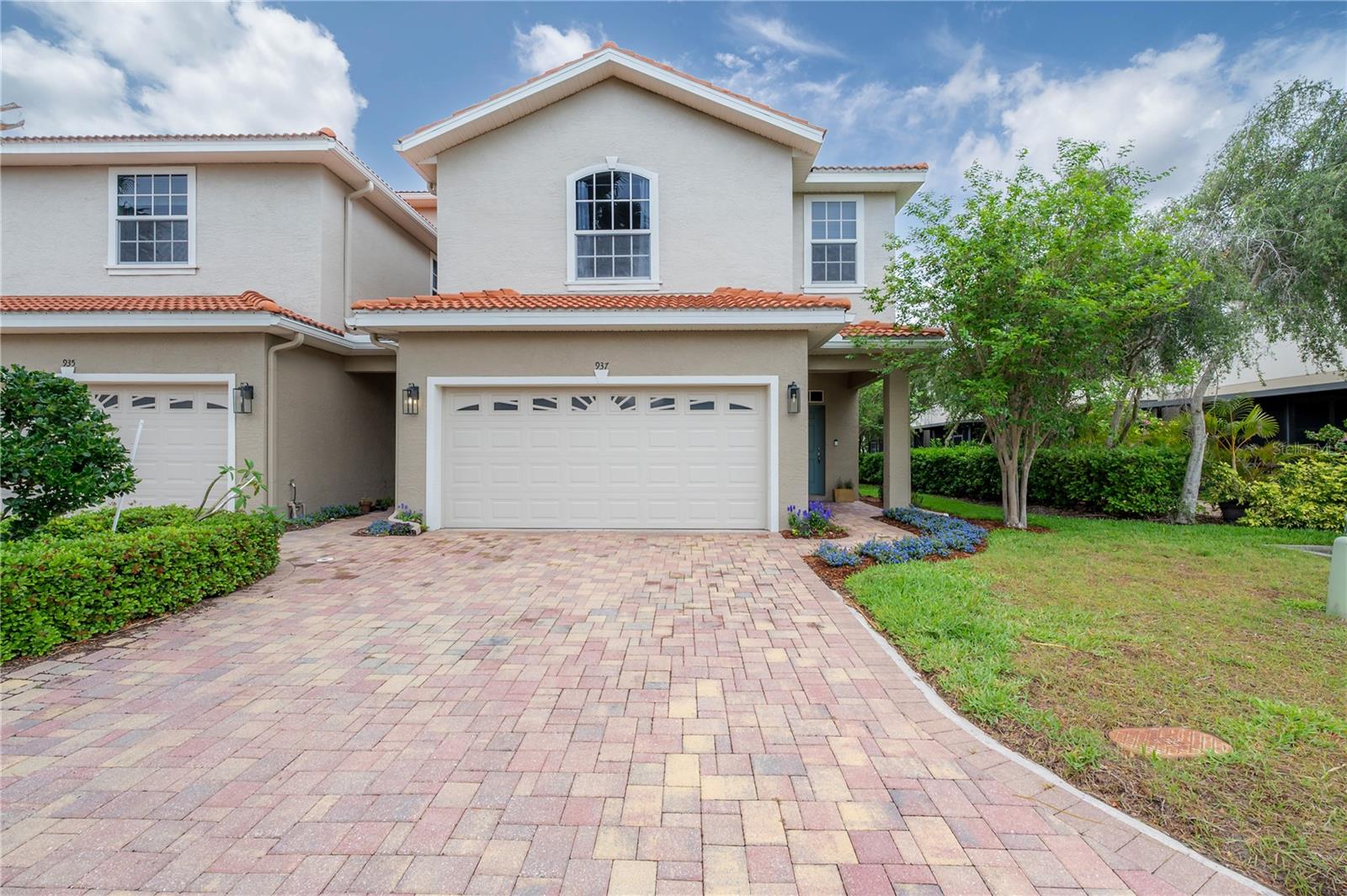 You will be impressed by all that this home has to offer! A rare package since you have it all in this a 3-bedroom, 2.5-bath, two-story tasteful townhome in a gated community with a pool.Built in 2014, the property shows like a model home. Meticulously maintained by its original and only owner, it has been upgraded with both builder design options and thoughtful post-purchase enhancements, creating a stylish and inviting interior. Perfectly situated in the quiet heart of the community, this corner unit features seven additional windows that fill the home with natural light and is steps from the pool. Step inside to be delighted by a spacious, open floor plan on both levels. The bright kitchen is a true highlight, showcasing top-of-the-line upgrades, quartz countertops, a large peninsula table with seating, solid wood 42” cabinets with crown molding, all-new hardware, under-cabinet lighting, a French-door refrigerator, double-oven range, 2021 Insinkerator Quiet Series disposal, built-in desk with drawers upgrades, and a generous pantry. Wood floors run throughout the first floor, while upstairs you’ll find an oversized loft with the upgrade of the entertainment wall and pre-wired sound system. The brand-new primary shower features a frameless glass enclosure and tiled walls, while bathrooms throughout have quartz counter-tops, custom tile floors and accents around the master jetted tub. Storage and organization are maximized with customizable built-in ELFA shelving in the pantry, closets, and garage (complete with workbench), all professionally installed by The Container Store. The garage also features an epoxy floor. A spacious covered lanai opens to your private backyard retreat, which can be paved and fenced with low hedges. Additional upgrades include: builder’s light fixtures replaced by hi-end custom light fixtures, upgraded outlet and light fittings throughout, upgraded Kohler faucets throughout, extra recessed lights upgrades in the common areas and stairs, laundry room cabinet, sink and folding table upgrades, Nest thermostat. Other features are: lanai screen extends past the building / covered area, under-stairs storage, tile roof, brick-paved driveway, 2024 exterior paint, and a new 2023 A/C blower motor. The home’s thoughtful design, modern upgrades, and prime location make it ideal for both relaxation and entertaining. While it provides a peaceful private retreat, it is also just minutes from coffee shops, restaurants, shopping, Safety Harbor, Tarpon Springs, and the beaches.Come visit, you’ll be enchanted from the moment you arrive!