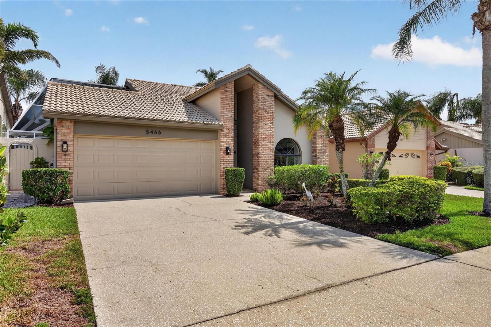 Pond-View Villa with Courtyard Pool | 2017 Tile Roof | Gated Chattam LandingWelcome to your serene pond-view retreat in gated Chattam Landing, a quiet 90-home villa community within Ridgemoor. The gated entrance adds an extra layer of security and peace of mind. This 3-bedroom, 2-bath, 2-car garage home offers 1,614 sq ft of heated living space designed for easy Florida living and effortless entertaining.An open floor plan flows from the living areas to a breakfast bar and French doors that open to the lanai. New ceramic wood style tile flooring creates a clean, continuous feel throughout. A wood-burning fireplace adds warmth and character, while the courtyard-style pool and screened outdoor living space turn everyday evenings into a private escape. Enjoy morning coffee to the sounds of nature and pond views that make the home feel like a true oasis.Peace of mind is built in: a concrete tile roof (2017), AC (2018), and block construction. The home is in Flood Zone X, so flood insurance is not required. The tile roof is part of the community’s well-kept standard, and the HOA handles weekly watering and yard maintenance along with trash removal—so the grounds stay beautiful without the weekend chores. Residents also enjoy Ridgemoor amenities including pickleball, tennis courts, a playground, and walking and bike trails through a tranquil, forested setting with frequent wildlife sightings.An attached 2-car garage and pond-view setting complete this rare mix of privacy, convenience, and low-maintenance living. Close to top Pinellas schools, shopping, dining, John Chesnut Sr. Park on Lake Tarpon, and a short drive to the Gulf beaches. Come see why this villa feels like a retreat from the hustle—and a place you will want to stay.