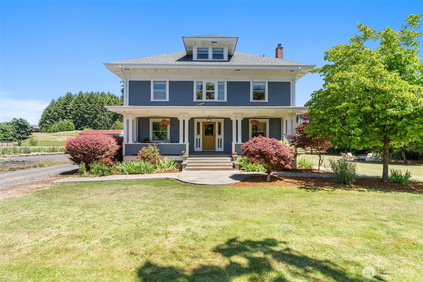 If walls could talk, this remarkable 1900 home would have more than a century of stories to tell. Set on 4 beautiful acres in Adna, this is a home that has been thoughtfully cared for and updated while preserving the craftsmanship & character that make this property so special. From the moment you step inside, you are greeted by stunning original woodwork, rich fir floors, original glass windows, and beautiful leaded glass details that reflects the master craftsmanship of an earlier time. The kitchen is the heart of the home and features custom countertops, milled from the maple tree standing near the front porch, creating a special connection to the property. Throughout the home, every detail speaks to a time when homes were built with quality, and beauty. Designed to be both welcoming & functional, the main level offers inviting spaces to gather or simply enjoy quiet time at home. The once formal living room, dining room, and charming parlor-TV room create a special feeling that makes this home a pleasure to live in. Upstairs, the spacious primary suite, additional bedrooms and bath, along with the third-floor living space provide flexibility for guests or multi-generational living. Beyond the home, the story continues with a carriage house, fenced pasture, greenhouse, machine shed, established blueberry field, and room to enjoy a country lifestyle. This property offers a rare opportunity to become the next steward of a truly special piece of Lewis County history.