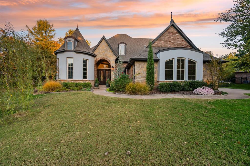 OPEN HOUSE SUNDAY 11/23 2-4 PM. Nestled on a manicured half-acre lot within the exclusive, tree-lined streets of coveted Bella Terra, this elegant French-inspired estate blends refined architectural detail with modern luxury. Set in one of Northeast Edmond’s most sought after communities, this residence was thoughtfully designed for both grand entertaining and effortless everyday living. Step inside to discover a beautifully curated interior featuring 4 spacious bedrooms in a private split plan, a sophisticated home office, and a custom-designed theatre upstairs. The gourmet kitchen boasts rich knotty alder stained cabinetry, an oversized island ideal for gathering, and a generous walk-in pantry, all crafted with impeccable attention to detail. The expansive enclosed outdoor living and dining area extends your entertaining space year-round, accented by a cozy wood-burning fireplace and framed by serene backyard views. Upstairs, the state-of-the-art theatre includes a diner booth, a fully equipped kitchenette with refrigerator, dishwasher, and icemaker, and comes complete with theatre seating and projector. The executive office exudes elegance with a curved wall of windows and accent-lit ceiling beams, while the luxurious primary suite offers a private retreat with a spa-style bath and a spacious closet with built-in vanity connected conveniently to the laundry. Outdoors, the backyard offers an additional venue for leisure and entertainment with a tiled patio and pergola. Additional features include a three-car garage with deep bays for larger vehicles, a storm shelter, and a spacious mudroom with custom storage. Residents of Bella Terra enjoy an elevated lifestyle surrounded by resort-style amenities: a sparkling community pool with cabana, playground, basketball court, and an active homeowners association. Enjoy award-winning Edmond schools while benefiting from lower Logan County taxes.