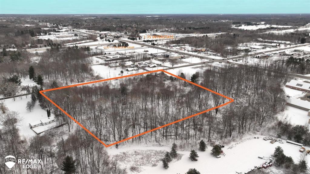 A rare development opportunity awaits in the heart of Clio's bustling business district. This expansive 9.64-acre parcel is strategically located just off the heavily-traveled I-75 corridor at the Vienna Rd exit, offering exceptional visibility and traffic flow, crucial for any commercial venture. All essential utilities are available on site or nearby, ensuring a seamless development process. Situated in an active business district by major national retailers such as Walmart, Menards, and various restaurants, creating a synergistic commercial environment. Turn your vision into reality! Contact us today to discuss the endless possibilities for this high-profile commercial property and schedule a private showing.