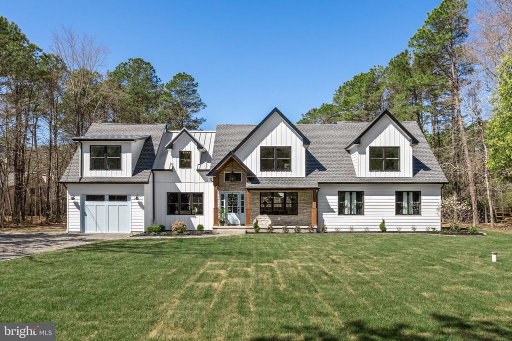 Stunning modern farmhouse—completely transformed from a 1,500 sq ft ranch into a two-story showpiece that feels like new construction. Reimagined exterior and expertly renovated interior offers bright, open-concept living with high-end finishes throughout. The chef’s kitchen is the heart of the home, featuring premium cabinetry, quartz countertops, a professional range, custom finishes, and an oversized awning-style window that fully opens to the outdoor living area. A custom butler’s pantry provides exceptional storage.  Additional main-floor highlights include a private office and an impressive in-home media room. All bathrooms showcase designer tile, modern vanities, and premium fixtures. The primary suite is a spa-like retreat appointed with premium materials and high end amenities. A freestanding soaking tub sits beneath a framed window for natural light and relaxation. A large, fully tiled walk-in shower features a frameless glass enclosure, rainfall shower head, handheld wand, and recessed niche storage. Superior craftsmanship and thoughtful design details make this custom home a true treasure. Prime location in the highly desirable Centennial Lake community. Schedule a showing today to experience this exceptional property.