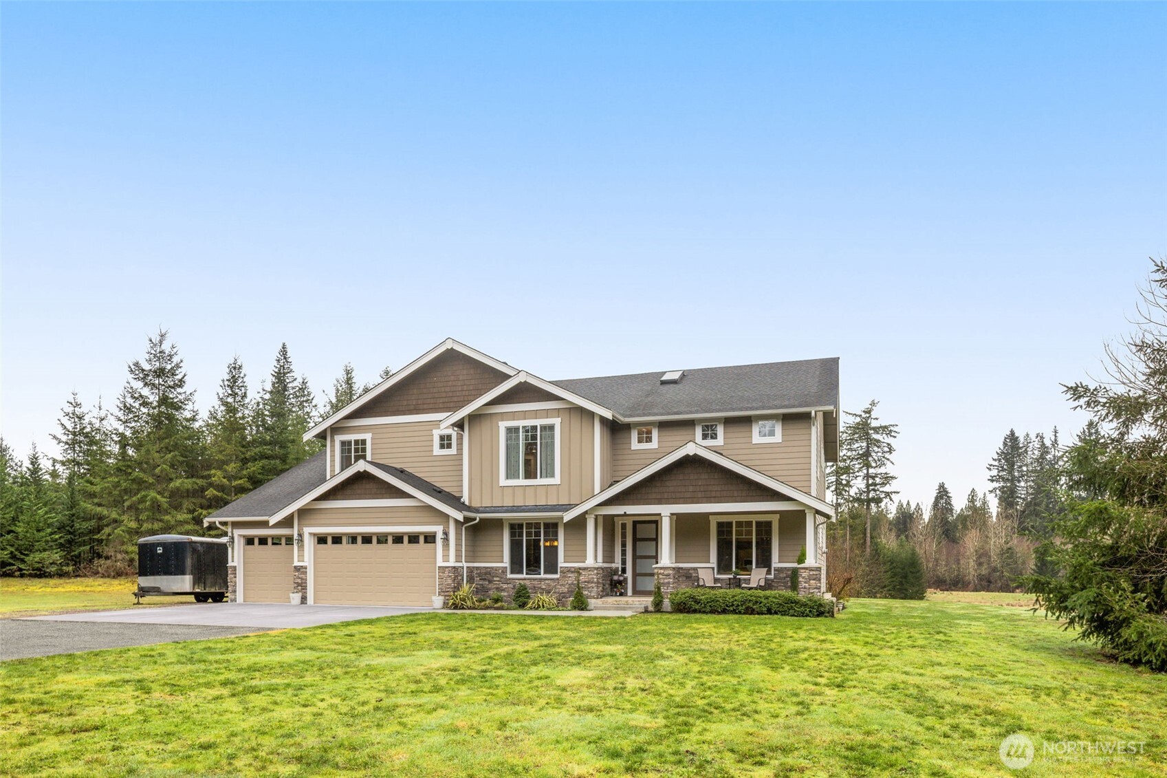 This exceptional home features 3,590 square feet of refined living, built in 2016, with a spacious floor plan, and breathtaking sunset views on approximately 26.7 private acres. With potential to subdivide, the acreage also presents a unique investment or future development opportunity, if desired. Thoughtfully designed for both everyday comfort and elevated entertaining, the home features; a chef’s kitchen with a large island, an office, a dining room, plus indoor and outdoor fireplaces—perfect for cozy evenings or gathering with guests year-round. The first floor also includes a butler’s pantry, 4-car garage and a desirable main-level bedroom and full bath, offering convenience and versatility. The second floor includes a bonus room, three bedrooms, a full bathroom, laundry room and a luxurious primary suite designed as a true retreat, complete with a spa-inspired en suite bath. Surrounded by natural beauty, this remarkable property is a great blend of privacy, opportunity, and convenience. Located close to the Snoqualmie Valley Trail, Lake Marcel and just a quick drive to downtown Carnation. Development and building information available upon request. Don’t miss this rare opportunity to build out a legacy development while living in a gorgeous, well appointed home!