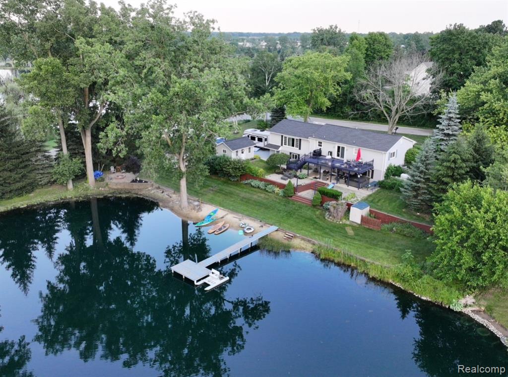 Welcome to this beautifully maintained 4-bedroom, 2-bath home offering peaceful lake living and exceptional views in every direction. Situated on a small lake with scenic views of another lake just across the street, this property provides a rare and tranquil setting.  As you step inside, you’re greeted by a spacious living room filled with natural light and stunning lake views, creating the perfect space for relaxing or entertaining. The home has been meticulously cared for, offering comfort, functionality, entertainers paradise and peace of mind with a whole home generator.  The walkout basement features a private master suite designed as your own personal retreat, with sliding-door access directly to a overhead covered hot tub that keeps you from rain or snow just outside, creating the perfect master oasis. Outdoor living is just as impressive, with a large deck overlooking the backyard and lakefront, ideal for enjoying sunsets, morning coffee, or gatherings with family and friends. Enjoy this beautiful quiet neighborhood. Imlay City Schools.Other features: RV WIRING, 40FT DOCK, HEATED 2 CAR GARAGE, LARGE FIRE PIT, 3 SHEDS, NEW ROOF 2021, 2023 HIGH EFFICIENCY FURNACE.  BATVAI