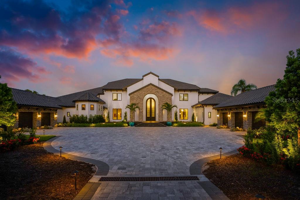 Welcome to Maison du Lac – a breathtaking lakefront estate that epitomizes unrivaled luxury, timeless elegance, and an extraordinary lifestyle. Situated on an expansive 2.7-acre lot along the prestigious Winter Park Chain of Lakes, this extraordinary residence showcases over 120 feet of pristine lakefront with sweeping panoramic views of the longest stretch of Lake Maitland.Blending classic Mediterranean architecture with state-of-the-art modern enhancements, Maison du Lac is a stunning fusion of enduring charm and contemporary sophistication. Originally constructed with timeless materials – including stucco exteriors and expansive windows – the home has been meticulously transformed into an 11,668-square-foot architectural masterpiece. Clean lines and open-concept living harmonize with rich textures and refined details, resulting in an environment that is both stately and smart.Upon entering through the grand 14-foot custom iron door, you are greeted by soaring dual staircases and exquisite finishes in marble, granite, and intricate moldings that reflect the home’s bespoke craftsmanship. A showstopping, $250,000 crystal chandelier—custom-designed and operable at the touch of a button—crowns the expansive great room, setting a dazzling tone for the professionally curated interiors. A private elevator adds convenience and accessibility across all levels of the home.The fully reimagined kitchen is a culinary showpiece, featuring top-of-the-line Wolf appliances, gleaming Cambria countertops, a large walk-in pantry, and expansive prep space ideal for entertaining at any scale. Whether hosting a lavish dinner or a relaxed brunch, the kitchen delivers both impeccable style and everyday functionality.The private master wing is an indulgent retreat, complete with a cozy fireplace, executive office, sauna, fitness room, and dual custom walk-in closets. Five additional en-suite bedrooms are thoughtfully positioned for maximum privacy, offering luxurious accommodations for family and guests. With seven full bathrooms and three half baths, the residence is ideally equipped for both refined daily living and grand-scale entertaining.For effortless indoor-outdoor living, multiple entertainment spaces flow seamlessly onto a sprawling lakefront patio. The outdoor summer kitchen, complete with a powered screen enclosure, provides the perfect setting for alfresco dining while enjoying sunset views over the water. A brand-new dock with a boat lift invites leisurely days spent boating, fishing, or simply relaxing on the lake.Outside, the estate continues to impress. Two serene fishponds with fountains create a tranquil sense of arrival, while the fully fenced and gated grounds ensure ultimate privacy. The residence is equipped with a full-home LUTRON smart system, offering intuitive control of lighting, ambiance, and automation. Additional features include a six-car garage, a resort-style swimming pool, newly updated landscaping, and custom exterior lighting.Maison du Lac is more than a home, it’s a lifestyle of distinction, privacy, and effortless sophistication. This is the lakefront living at its finest.