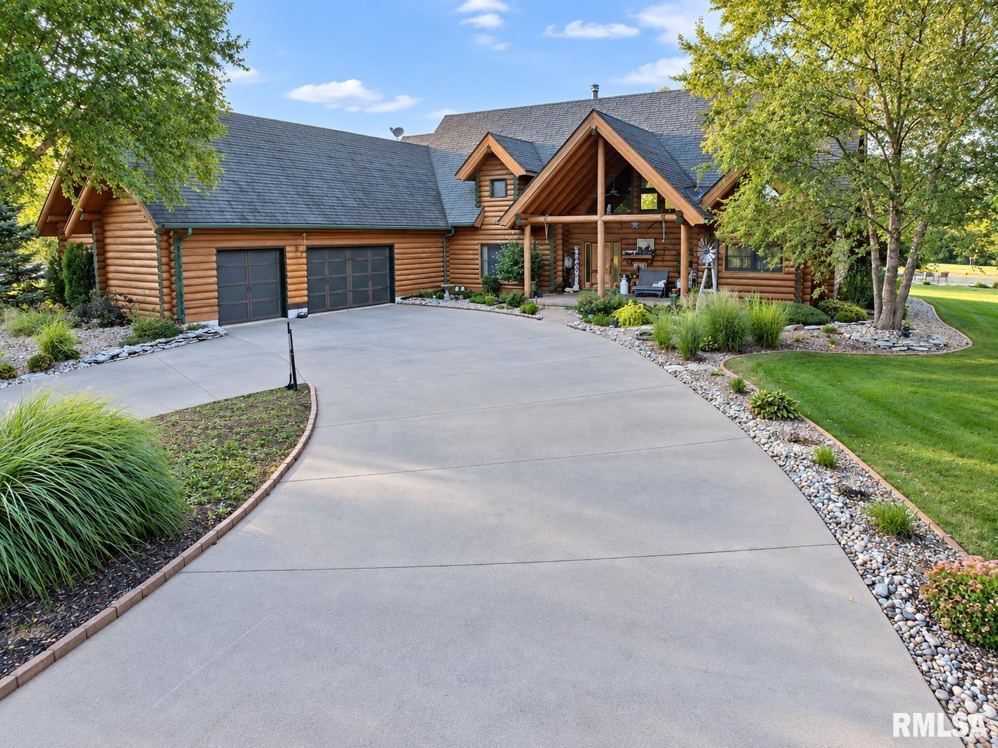 Custom-built luxury log home offering over 4,000 sq. ft. of finished living space on more than 5 acres with a lake, private beach and pool. The impressive interior showcases authentic log construction, soaring ceilings, exposed beams and a dramatic floor-to-ceiling stone fireplace and chimney anchoring the open-concept great room. Hickory flooring, abundant natural woodwork and expansive living spaces continue the distinctive lodge-style character throughout. The primary suite offers a spacious retreat with vaulted ceilings and a beautifully updated bath featuring a freestanding soaking tub and oversized tiled shower. Finished lower-level living space provides additional room for entertaining, recreation or everyday living, along with extensive storage throughout the home. Outdoors is equally impressive with a large deck, multiple gathering areas and an above-ground pool overlooking the lake. The expansive lawn leads to the private beach and waterfront, creating exceptional space for outdoor living, entertaining and enjoying the setting. Additional features include an attached 2-car garage, two water heaters and generous storage. A rare opportunity combining custom log-home craftsmanship, substantial finished living space, acreage, water and resort-style amenities in one extraordinary property. Must be pre-approved buyers and must not be sick when viewing home.