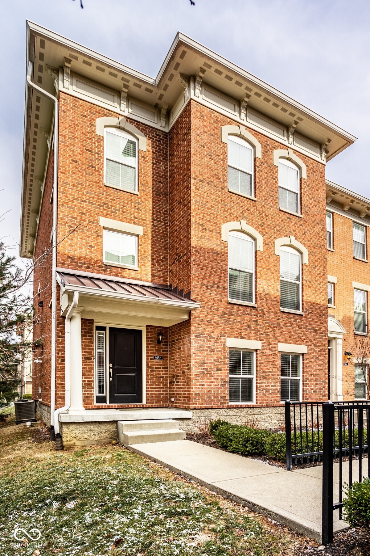 Beautifully updated townhome in highly desirable location at 96th and Meridian Street. This is an exceptional opportunity to enjoy maintenance free living. The kitchen offers style and functionality. The large kitchen island with stone countertops provides ample workspace and counter seating. New cooktop, refrigerator, garbage disposal and faucet. This end unit townhome offers an open floor plan with flexible spaces. Lowest level includes a wet bar and full bath, main floor includes Kitchen, breakfast nook and living room with a gas fireplace for cozy nights. Additional flexible space to be a formal dining room, den or office. Upstairs includes 3 bedrooms, 2 full baths and a convenient laundry room with a stackable LG  washer and Dryer  LVP flooring 2 years new, carpet 2 years new, Elfa custom closets and Elfa garage shelving for extra storage. Garage floor is epoxy coated. Too many upgrades to list. Located near I-465 and everyday conveniences. Don't miss this one!