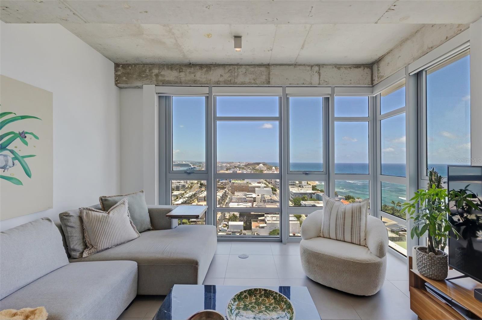 Wake up to amazing panoramic views to the ocean, city hall and colonial forts from the tallest modern building in Viejo San Juan. Atlantis is close to everything, walking distance to Escambrón beach, Luis Muñoz Rivera park, boutiques, and centric to the best nightlife and restaurants. This renovated apartment on the 16th floor is a smart home with light switches, power outlets, thermostats and door lock all connected to your phone and voice. It has a spacious primary bedroom with ensuite bath and walk in closet, a secondary bedroom/office, a guest full bathroom, kitchen with stainless steel appliances, and in-unit laundry. Includes 2 parking spaces side by side (plus visitor parking). Enjoy building amenities like a fully equipped gym, business center with WiFi, stunning events room, 2 full power generators for the whole building, water cistern and 24/7 security. Full service staff from concierge to janitorial. Includes high-end furniture, stunning light fixtures and custom window blinds for a truly turn-key experience.