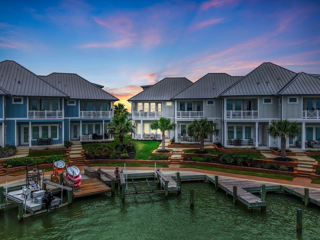 Experience effortless coastal luxury in this waterfront 4-bedroom, 3.5-bath villa located in a prestigious gated community, complete with a private boat slip and offered fully furnished, turnkey. Designed for low-maintenance living, the HOA covers exterior maintenance, landscaping, and insurance—including windstorm, flood, and homeowners—so you can focus on enjoying the lifestyle. Coastal finishes and designer touches elevate the open-concept living and kitchen area, featuring a quartz island, gas stove, full appliance package, and serene water views from the rear windows. Step out onto the covered back porch to savor quiet mornings by the water. The second floor hosts two guest bedrooms and a spacious primary suite with a private balcony, while the third-floor bedroom with en-suite bath offers flexible use as a media room, game room, or office. Additional parking next door frees up the garage for your golf cart and beach gear. Community amenities include a resort-style pool, a 500-foot lighted pier, and over two miles of scenic boardwalk for walking and biking, all surrounded by tranquil wetlands—creating a true nature lover's paradise. Perfect for families seeking a relaxed, lock-and-leave coastal retreat where luxury meets simplicity.