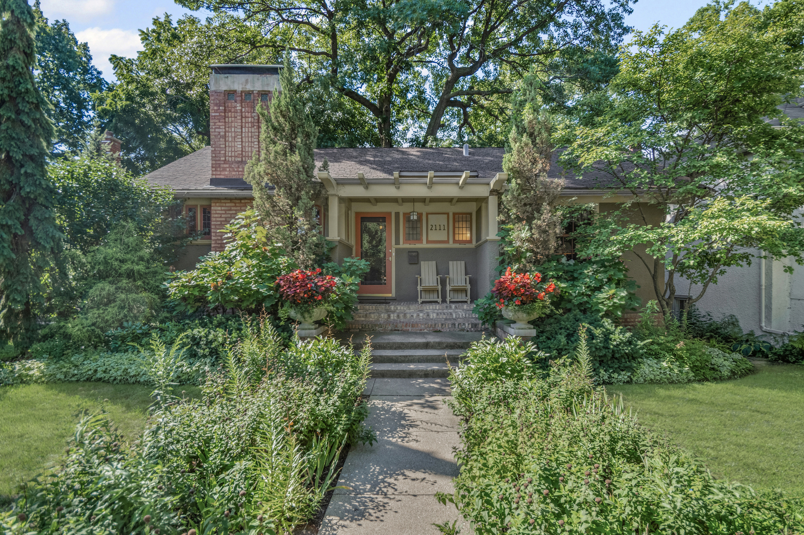 This rare 1911 Craftsman-Style 3 BR / 2 BA bungalow is a true gem in West Ridge, unlike anything else on the Far North Side. Built around a towering red oak tree, this U-shaped stucco home features striking architectural details by renowned architect George W. Maher. Post-and-beam entry porch opens to a barrel-vaulted foyer and living room that make a dramatic first impression with natural oak woodwork, original leaded glass windows and an inglenook gas fireplace with built-in oak benches and bookcases. Separated by French doors, the bright dining room is surrounded on three sides by casement windows, filling the space with abundant natural light. Renovated kitchen offers oak cabinetry with glass-front doors, granite countertops, and a square tile backsplash, complemented by Arts and Crafts inspired pendant lighting and decorative borders, along with a Sub-Zero refrigerator and SS appliances (oven, dishwasher, microwave less than 5 years old). This home was made for entertaining! A back door off the kitchen opens to a generously sized Trex deck (new in 2023) and a beautifully landscaped backyard. The spacious outdoor area features a brick paver patio, tranquil pond, potting shed and a two-car garage - perfect for gatherings or everyday enjoyment. All three bedrooms are generously sized and conveniently located on the first floor, along with a full bathroom - renovated in 2010 to complement the home's vintage charm with the original tub, pedestal sink, classic subway tile, and sconces. Light-filled lower level features an expansive family room w/decorative fireplace and built-in bookshelves (perfect as a home office or additional bedroom), full bath with walk-in shower, large laundry room with chute and ample storage. All big projects are already done for you - roof (2018), water heater (2021), boiler and central air (2022). Only minutes away from Indian Boundary Park, local grocery stores, restaurants, CTA and just 5 blocks to the Metra. This home is meticulously maintained and thoughtfully designed, this remarkable opportunity should not be missed!