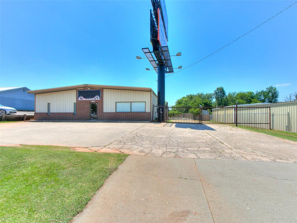 Don't miss out on this 1/2 acre mol, HWY 152 frontage property near the heavily traveled intersection of Morgan Rd. Concrete parking lot, 3,000sf building has recently updated reception area, office, kitchenette, & bathroom. The shop area has 2 overhead doors, (1) 10x9 & (1) 10x12 w/openers, & an air compressor. This property has 3 phase electric & per the City of Mustang is currently zoned C-5. Property has City Water and Septic.  Having been a towing company in the past, this property is fully fenced & has ample parking behind the gate. Storage container in the back will remain. Buyer to verify all information.   Seller is selling the property AS IS.