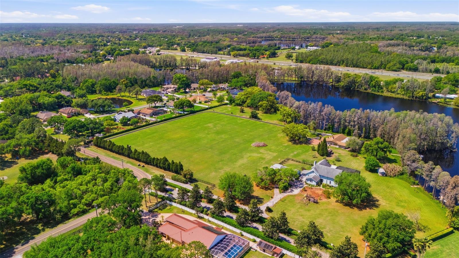 Positioned along the shores of Lake Kell in Lutz, this is a rare opportunity to control a meaningful stretch of private waterfront in one of the Tampa Bay area’s most supply-constrained segments. The property has been evaluated for its ability to accommodate up to ten luxury residences, including multiple directly on the water. Delivering this level of density on a private lake with no public access is increasingly rare, creating a high-demand product with limited direct competition. Preliminary layouts and planning concepts are already in place, providing a clear path forward for a builder or developer ready to execute. The site offers flexibility to phase construction, build and sell, or develop a cohesive waterfront enclave with strong market positioning and pricing power. Lake Kell’s private nature, minimal boat traffic, and calm waters support the lifestyle today’s luxury buyers are actively seeking. This is a controlled, low-density waterfront setting that enhances long-term value and buyer appeal. The existing 3-bedroom, 2-bath pool home, approximately 2,376 square feet, provides immediate on-site utility. It can serve as a development office, model center, or operational hub during construction, reducing overhead and improving efficiency. Alternatively, it can be retained as a guest residence within a larger end-user compound. For builders focused on delivering differentiated product with strong absorption potential, this site checks all the boxes. True waterfront exposure, scalable density, and the ability to create multiple premium homesites within a private lake setting. Opportunities of this scale, with this level of flexibility and upside, are increasingly difficult to assemble. This is a chance to step in, control the waterfront, and bring a high-demand luxury product to market.