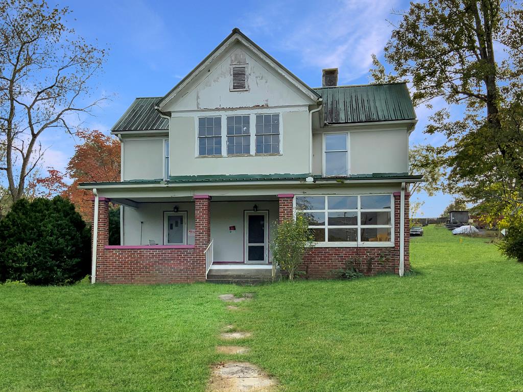 Seize the chance to own a piece of history with this captivating 1903 home, commanding attention on a sprawling 1.69-acre double lot in the heart of Andrews' evolving Main Street district. This five-bedroom, two-bath treasure, zoned for central business, is a versatile canvas—ideal for a warm residence, boutique retail, charming inn, or innovative commercial space. Envision relaxing on the welcoming front porch, taking in stunning mountain views, or wandering the expansive, level grounds with a gentle stream flowing along the property's edge. Inside, the home's original floor plan shines with distinctive stonework and historic charm, bolstered by a recently updated metal roof. Uncover the storied rock room behind the generous country kitchen, whispered to connect to Abraham Lincoln's lineage. With a billboard on-site delivering immediate income, this property beckons for your vision to reimagine its potential. Schedule a visit today and let this Andrews diamond in the rough spark your inspiration!