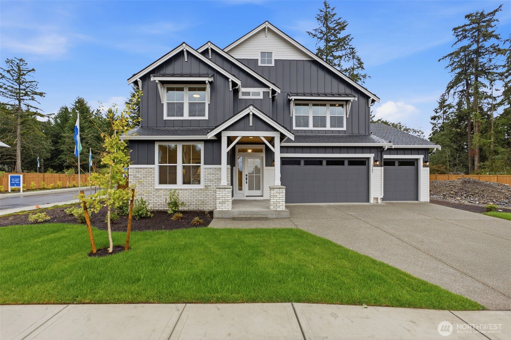 MOVE-IN READY at Carrera Oaks! Skip the build time and come see this finished ROGUE by PACIFIC LIFESTYLE HOMES, packed with designer upgrades and truly ready for you NOW. Let’s start with the unicorn: a MASSIVE 5-CAR GARAGE. Cars, bikes, toys, tools, holiday decorations you swear you’ll organize someday—there’s room for all of it.    Inside, the main floor features a private office plus an open-concept living space with a dramatic 2-story great room, Chef’s kitchen with GAS cooking and designer details throughout—including a gorgeous painted shiplap fireplace. Upstairs you’ll find 3 oversized bedrooms, 2 bathrooms and big windows bringing in tons of natural light.    Outside? Bring your dogs, bring your friends, bring your frisbee because this yard is HUGE, fully landscaped with irrigation FRONT & REAR plus a large covered patio ready for PNW entertaining.    And when we say move-in ready, we mean it: FRIDGE + WASHER + DRYER are ALL INCLUDED. No waiting for construction. No appliance shopping. Just bring your furniture and start unpacking.    Carrera Oaks is an intimate 41-home community surrounded by 5 acres of protected green space, just 10 minutes to JBLM and 12 minutes to downtown Tacoma. It feels tucked away while keeping you close to everything.    Brokers must accompany buyers on initial visit for full compensation. Site office open Sat-Tues 11-6 & Wed 1-6. Come see why Carrera Oaks feels different!