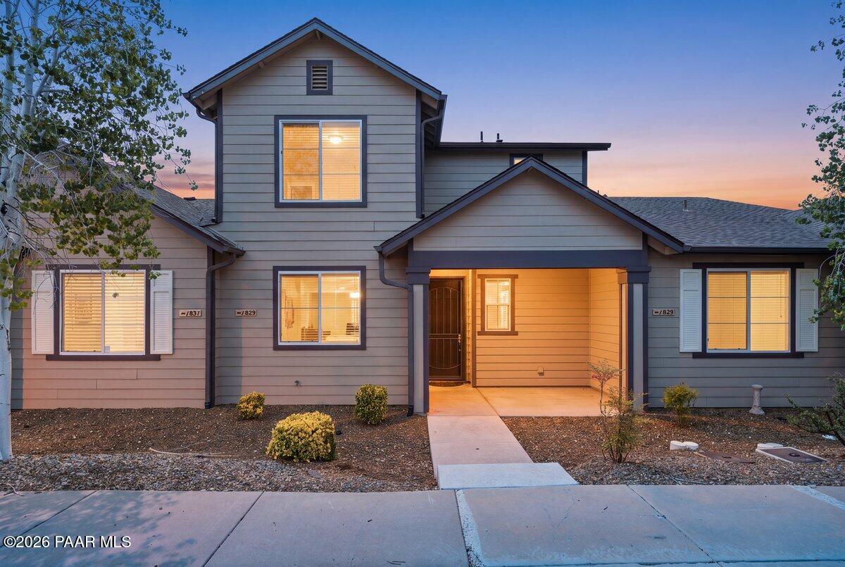 Beautifully upgraded townhome in one of Prescott Valleys most popular subdivisions! This gorgeous home is the perfect weekend getaway from the heat of the valley, or full-time living with minimal maintenance required.. The exterior is maintained from landscaping to roof by the HOA, and the interior is stunning, with new paint throughout! From the moment you walk through the front door you're senses will be delighted by the tastefully designed interior. Beneath your feet are beautiful luxury plank flooring and above your head are soaring 20 foot ceilings with in the living area. The spacious living room has two levels of windows for plenty of natural light. The kitchen cabinets boast two tone paint, granite countertops with black quartz farm sink (with great views of the park) and high end stainless steel appliances. Inside the laundry room you'll find LG extra large  frontload washer and dryer in a beautiful granite color, with a stainless steel cabinet sink. The bathrooms have all been updated with the same beautiful granite counters and contemporary countertop vessel sinks, shower doors and black faucets with matching cabinetry hardware. The primary bedroom is located downstairs for main level living, and features a walk in closet and another beautifully upgraded bathroom. There is access off the living room to a cozy outdoor patio area, perfect for enjoying the wonderful weather no matter what time of year. The 2 car garage, with a brand new insulated door and newly installed water heater, is at the back of the home off the alley for easy access and added privacy. Upstairs, the loft has been enclosed to offer a more private area for the flex room, which can be used for whatever your needs may be. There are also two spacious bedrooms and a full bath. There are windows along the wall of the loft to allow light to stream in from the back windows and the bedrooms have  nice views of the nearby mountains. Located close to the golf clubhouse and across from one of the many parks this subdivision has to offer...there are plenty of walking paths to be enjoyed as well! The main clubhouse has a fitness center, community kitchen, game room, indoor and outdoor pools and a tennis court. And you can't beat the location! You have access to shopping and dining, along with sporting good stores, coffee shops and fast food without ever having to go onto the highway! So much to love about this home and the wonderful neighborhood that is Stoneridge!