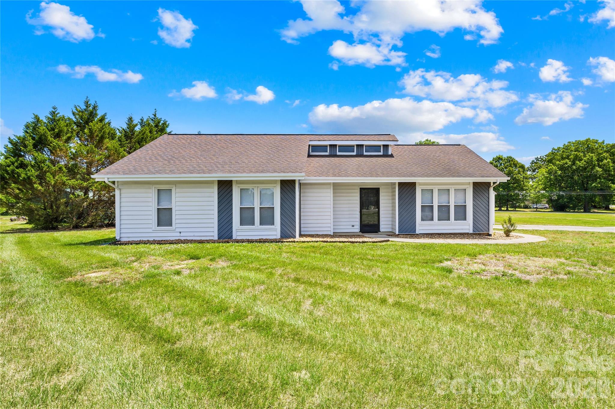 Fully Updated Ranch on Over an Acre with Detached Workshop Garage! Move-in ready and beautifully renovated, this impressive ranch home sits on a spacious 1+ acre corner lot and offers the perfect blend of modern updates, functionality, and convenience. A standout feature of this property is the 24x24 detached garage/workshop with electric, complete with front and rear roll-up doors, ideal for hobbies, storage, projects, or additional workspace. Inside, you’ll immediately notice the attention to detail with smooth ceilings, new luxury vinyl plank flooring, updated baseboards with all new lighting and fixtures throughout. The natural light and soaring ceilings in the living room are sure to impress along with the stunning kitchen and completely redesigned new cabinetry, quartz countertops, stylish backsplash, and sleek black stainless steel appliances. A new tankless gas water heater adds efficiency, and the washer and dryer are included for added move-in convenience. Each bedroom is thoughtfully equipped with custom closet systems, while the primary suite offers a true spa-like retreat. The luxurious primary bathroom features a modern hydro-powered LED shower panel system with rainfall and waterfall overhead shower options, adjustable body massage jets, and a handheld sprayer. This turnkey property offers peaceful living with room to spread out, all while being conveniently located in an excellent school district just minutes from the 74 Bypass, less than 10 minutes to Wingate University, and convenient to downtown Monroe. Make plans today to see this beautiful property or check out the virtual tour!