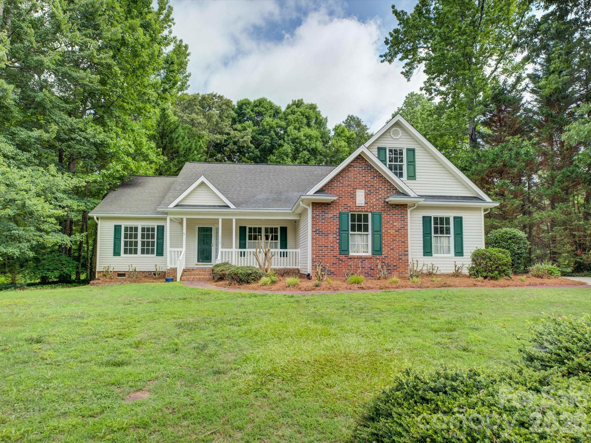 Tucked away on a quiet cul-de-sac, this home sits on one of the largest lots in the neighborhood with a private wooded backdrop that is hard to find. Three bedrooms and two full baths are all on the main level, including the primary suite, keeping everyday living easy and accessible. A fourth bedroom and loft with its own private bath upstairs adds flexibility for guests, a home office, or a bonus retreat. Real hardwood floors, fresh paint, new carpet, and all new stainless steel appliances make this one truly move-in ready. Outback enjoy the trees and privacy beyond from either the screened porch or the recently updated deck. Just minutes from Martha Rivers Park!