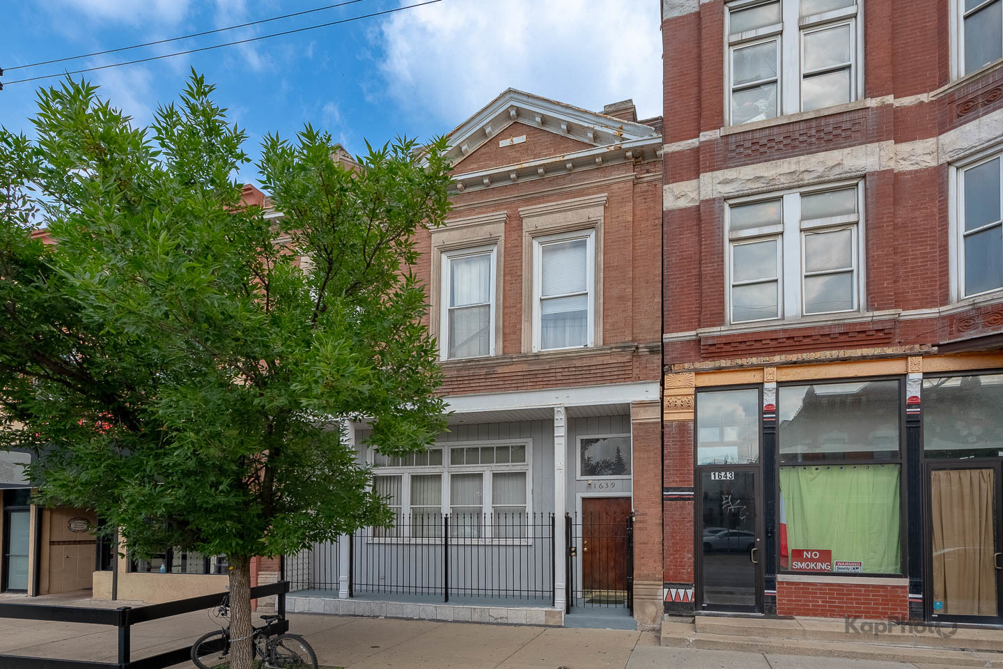 Prime mixed-use investment opportunity in the heart of Pilsen! Property is currently set up as a single-family home and building will be vacant at closing.  This historic brick building, built in the late 1800's, offers approximately 4,000 sq ft across multiple units with strong potential rental income and future upside. The first-floor features an open-concept layout with two large rooms, laundry, fireplace, a spacious kitchen, and a full bath. The basement has 2 bedrooms / 1 bath (~1,500 sq ft) with 9ft ceilings. The second floor offers a full 3 bedrooms, 2 full baths, 2 gas fireplaces, an enclosed porch and wet bar for year-round entertaining.  There is also an outdoor rooftop deck boasting stunning skyline views. Interiors include hardwood and tile flooring, in-unit laundry, recessed lighting, generous closets. Rare attached 2-car garage included.  This is a very unique and well cared for property. The basement is fully finished and set up with two more bedrooms, full bath, kitchen and laundry.   Cash or Commercial Financing will most likely be needed for purchase (Building is zoned C1-2).      Located on bustling Blue Island Ave, just steps from 18th Street, CTA Pink Line, UIC, and the Medical District, this property benefits from a 96 Walk Score and a 99 Bike Score. Surrounded by Pilsen's vibrant dining, art, and cultural scene, this is an unbeatable live-work-invest opportunity. Whether you're looking to stabilize income, renovate for higher rents, or add a boutique storefront, 1639 S Blue Island delivers exceptional potential.    Property sold "As Is"