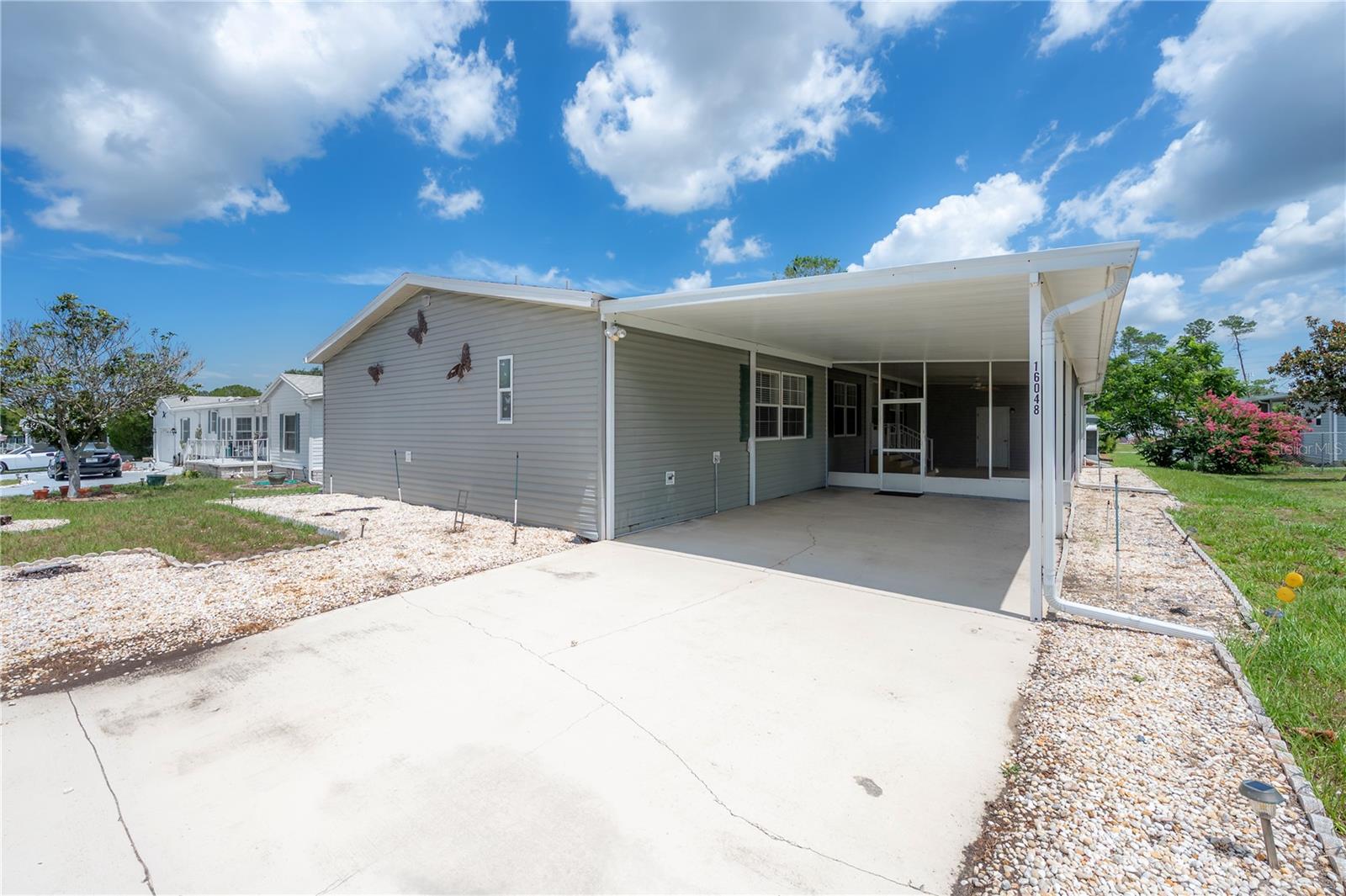 Welcome to 16048 Brookridge Blvd, Brooksville, FL 34613, located in the highly desirable gated 55+ Brookridge Golf & Country Club community. This spacious 4-bedroom manufactured home offers incredible potential for buyers looking to renovate, personalize, or invest in a property within one of Hernando County's most active adult communities. Inside, you'll find an open-concept floor plan featuring a spacious primary suite complete with a private bathroom and walk-in closet. The home offers a large dining room, a cozy breakfast nook, and plenty of living space for entertaining family and friends. A generously sized laundry room and pantry provide added convenience and storage. Outside, you'll find an additional storage unit, perfect for tools, golf equipment, seasonal items, or extra storage needs. Major updates include a new roof installed in 2025 and an A/C system replaced in 2018, providing peace of mind on two of the home's most important components.  Residents enjoy an abundance of amenities including a clubhouse with a heated pool, fitness room, library, tennis courts lined for pickleball, shuffleboard, bocce ball, horseshoes, pavilion, and a full calendar of social activities. Golf enthusiasts have the option to join Brookridge Country Club and enjoy a beautifully maintained 6,054-yard, par-72 championship golf course featuring rolling hills and updated greens installed in 2020. Conveniently located near shopping, dining, medical facilities, and Florida's beautiful Nature Coast attractions, this home offers the perfect blend of affordability, community living, and endless potential.